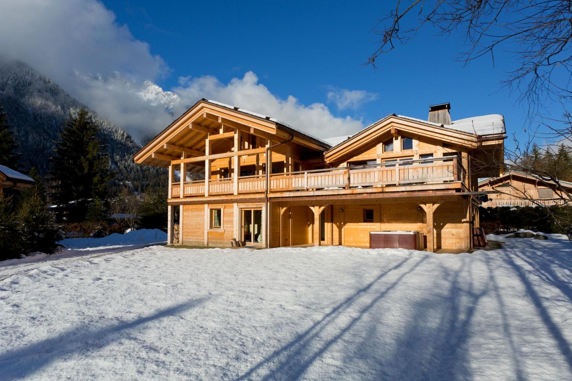 Chalet exterior with wrap-around balcony and covered hot tub