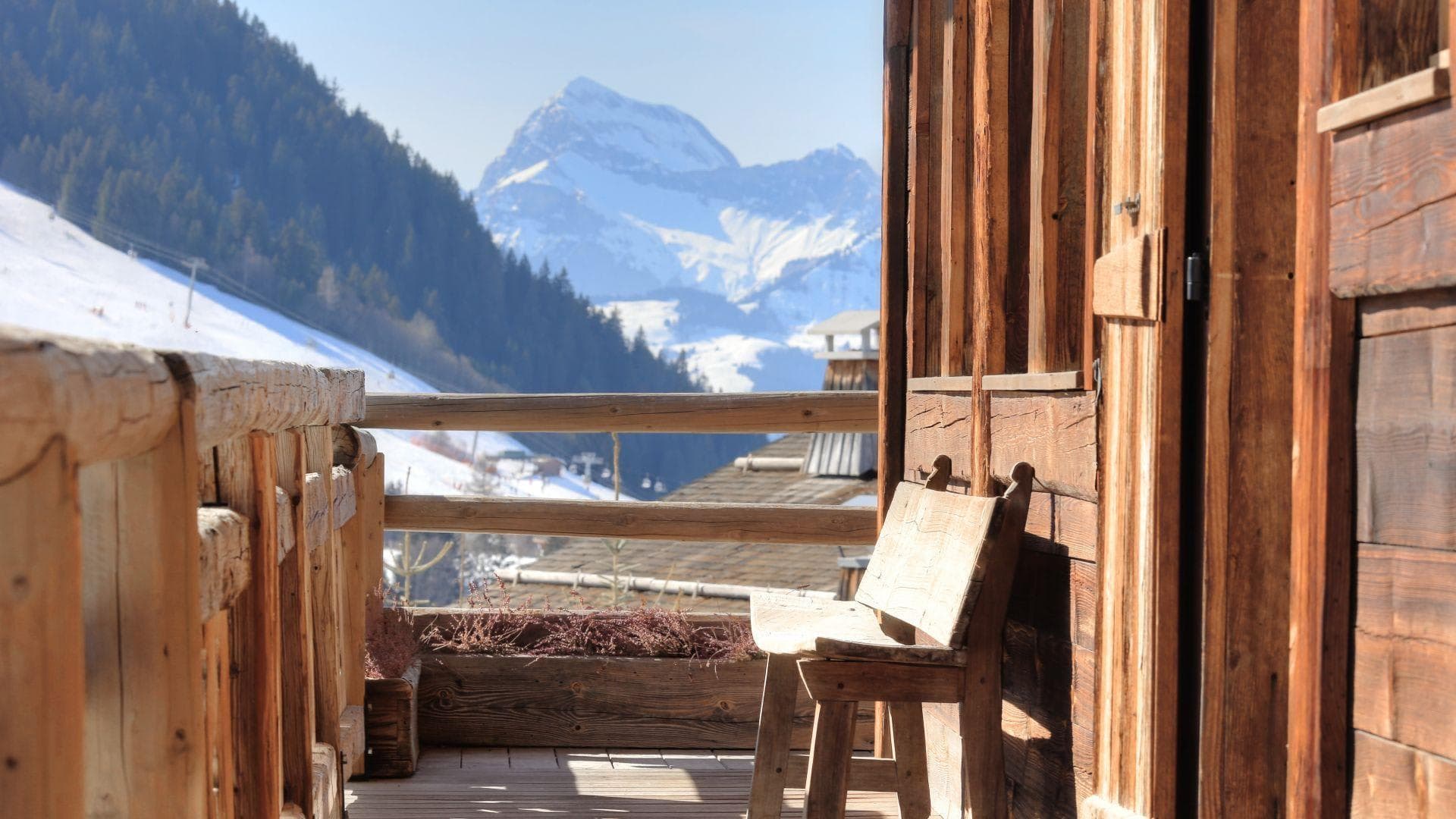 Wooden deck with mountain views; rustic bench seating