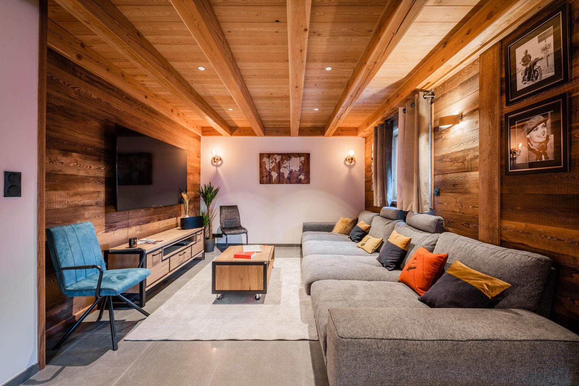 Media room with large smart TV and oversized sectional sofa