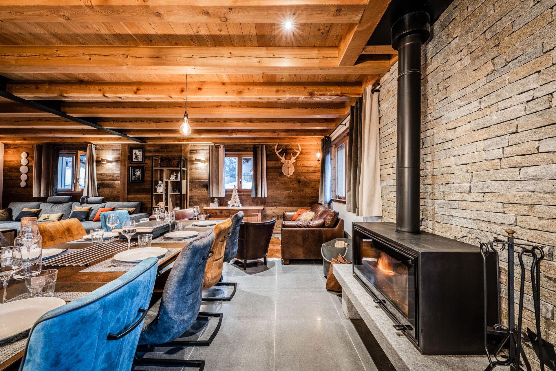 Open living area with wood-burning fireplace and dining table for 8