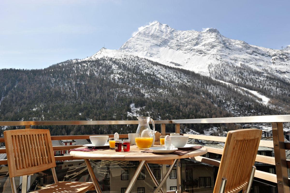 Private balcony with cafe seating and direct alpine views