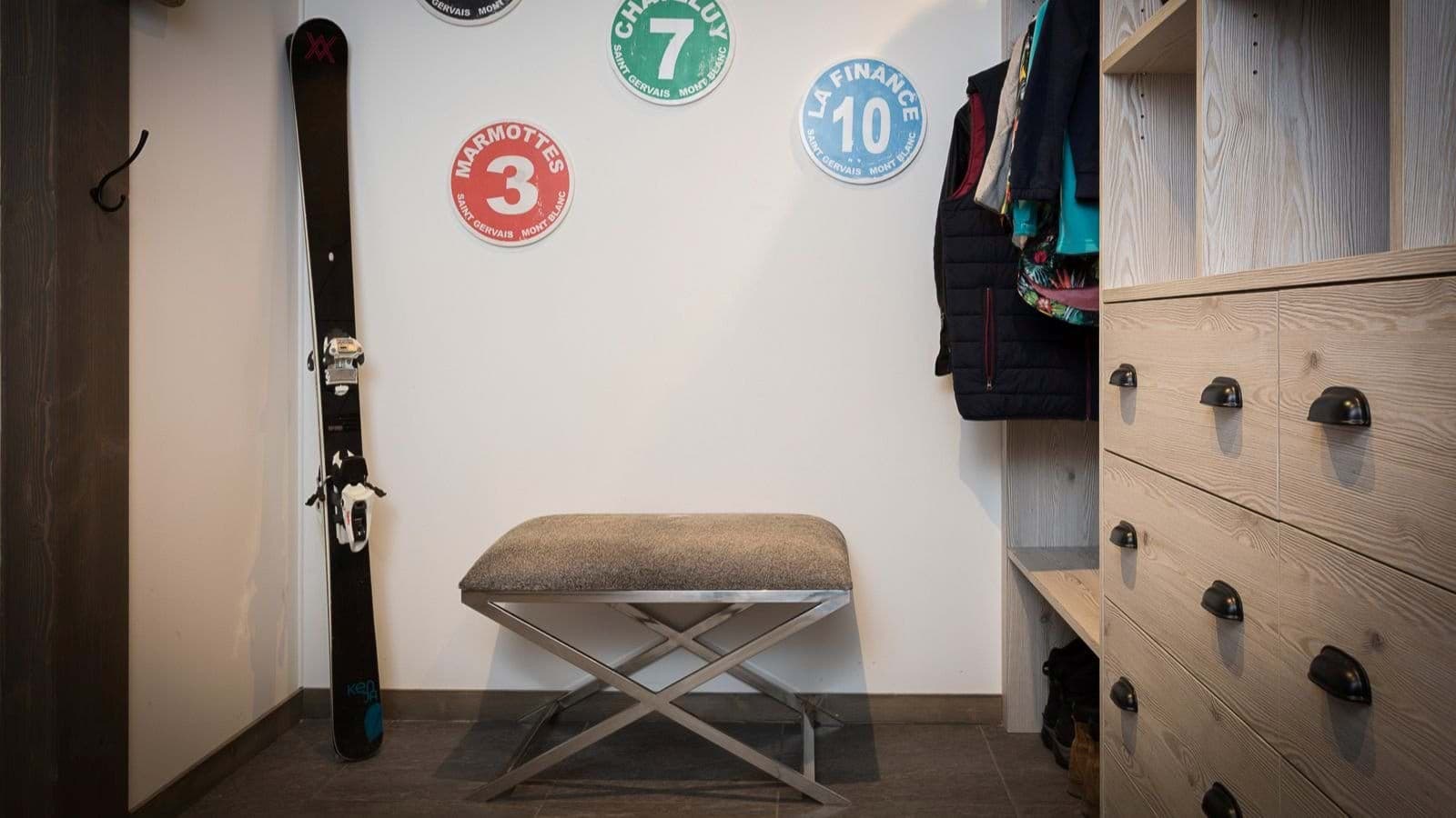 Ski storage and mudroom with bench seating and built-in dresser