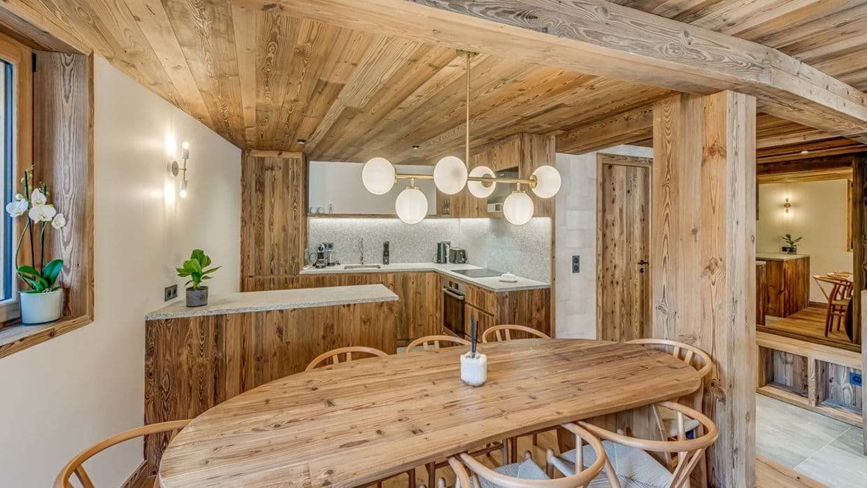 Open-plan dining area and kitchen with reclaimed wood finishes