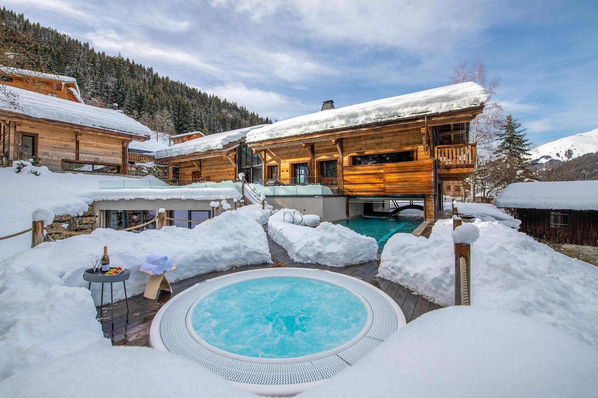 Outdoor hot tub and heated swim-in pool with mountain views