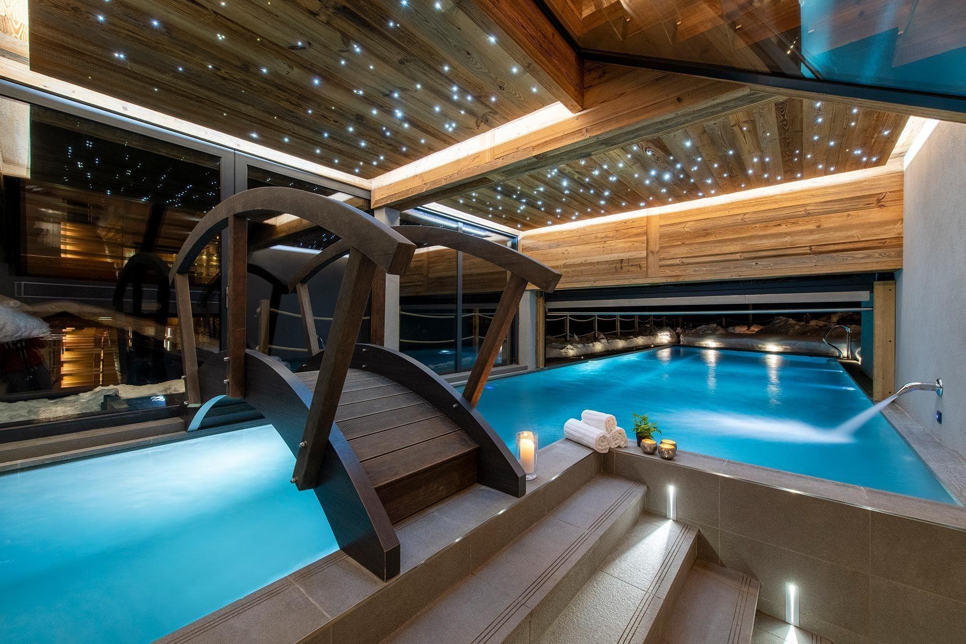 Indoor-outdoor heated pool with bridge and fiber optic star ceiling