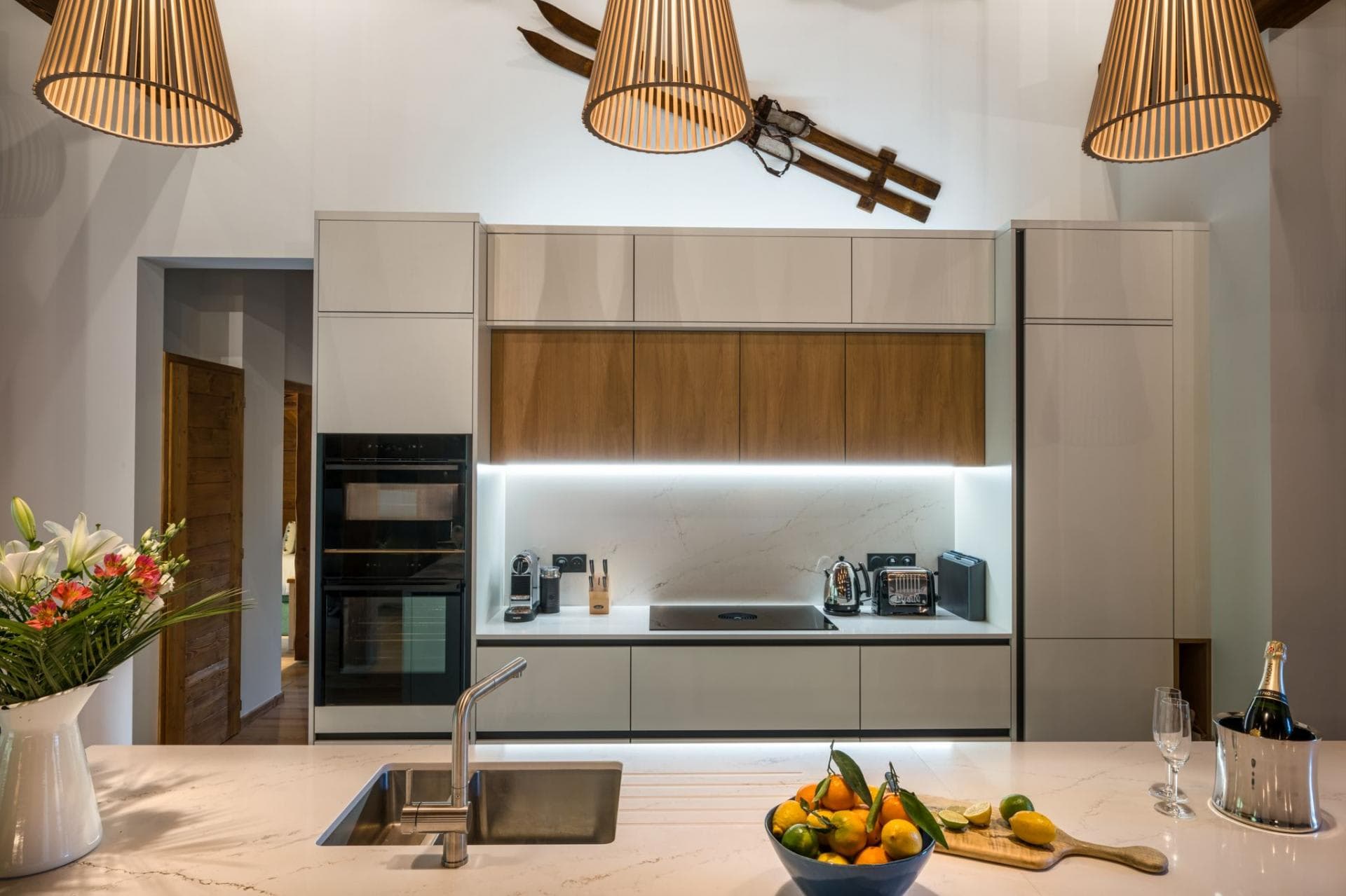Kitchen with induction cooktop, double wall oven, and Nespresso machine
