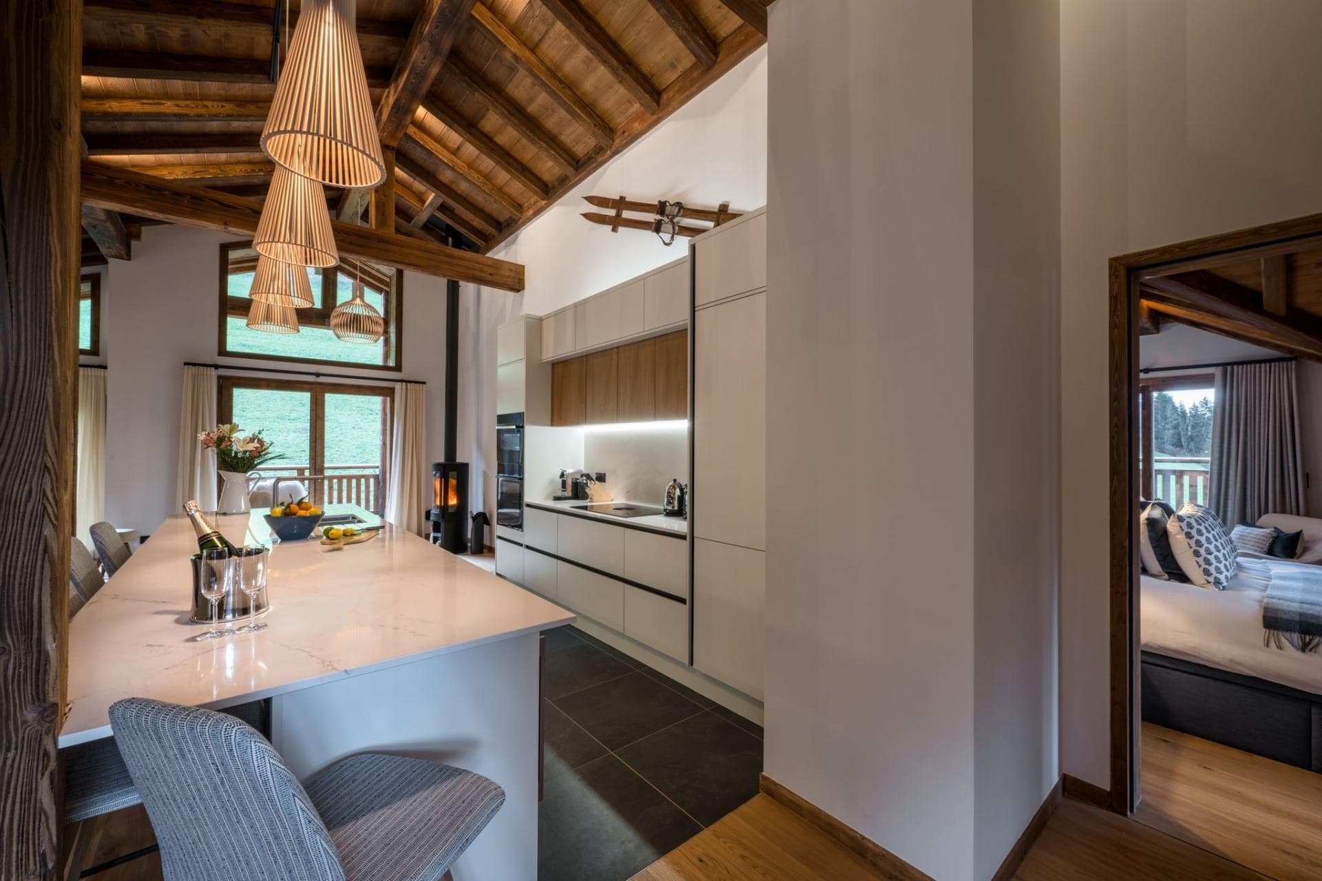 Open-plan kitchen with induction cooktop and wood-burning stove