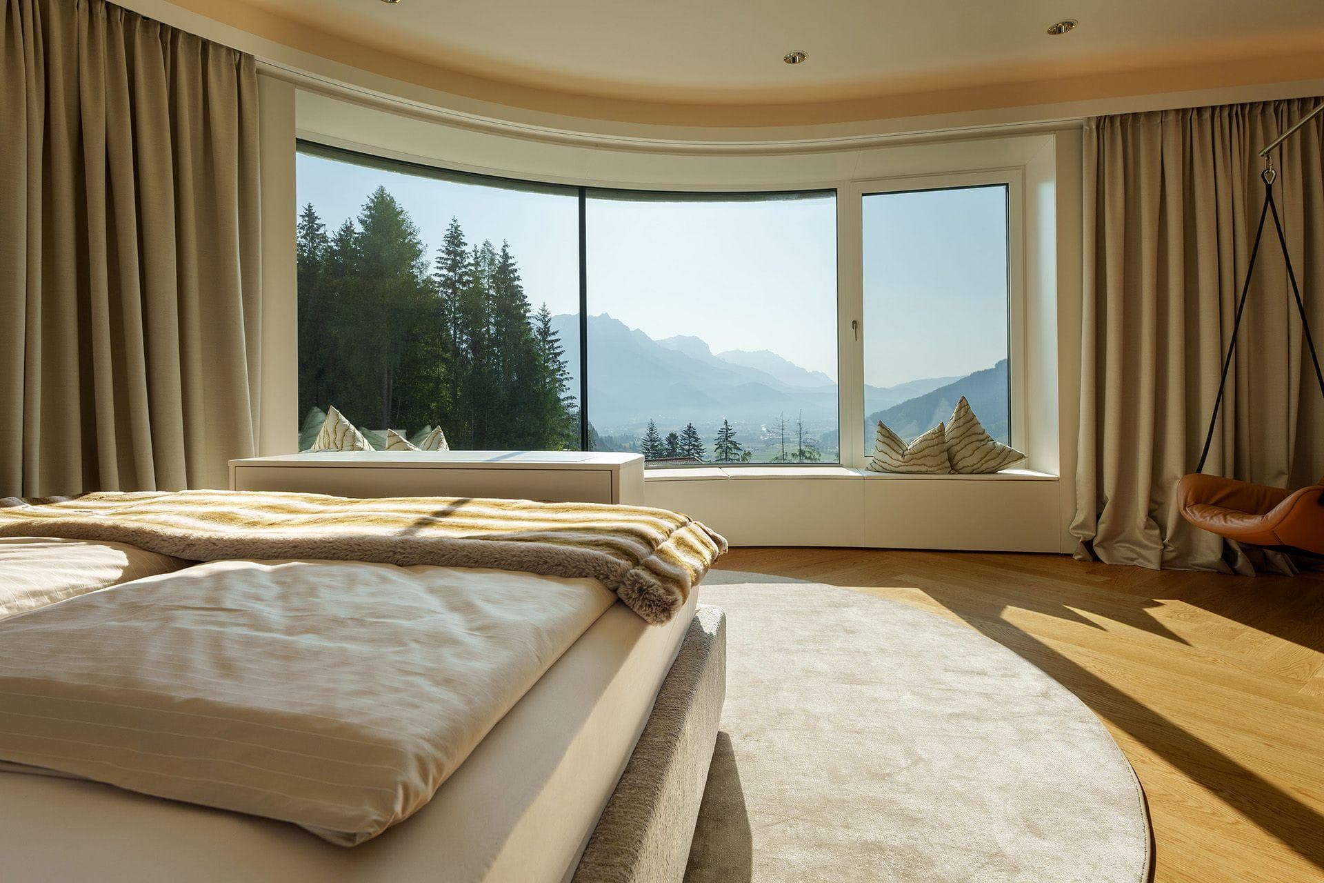 Primary bedroom with panoramic mountain views and window seating