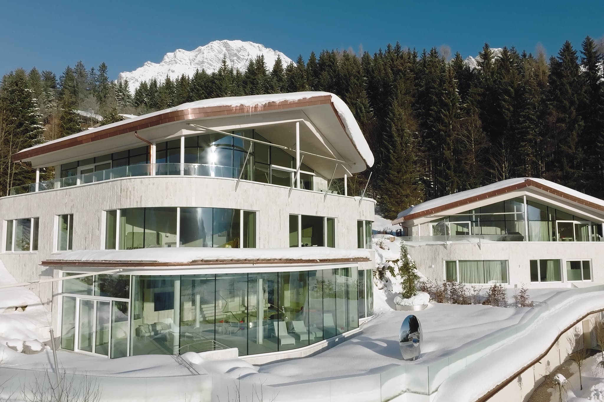 Chalet exterior with mountain views and ground-floor wellness area