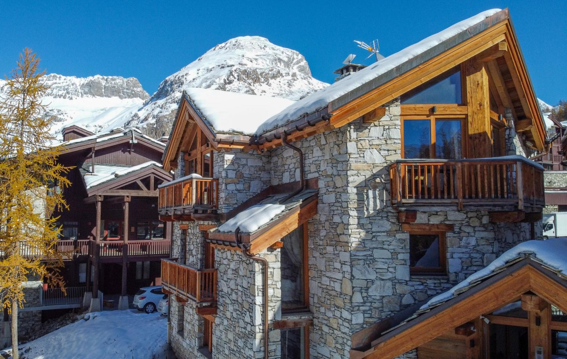 Stone chalet exterior featuring private balconies and high-altitude mountain views