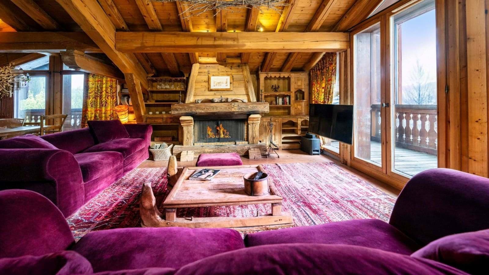 Living room with wood-burning fireplace and balcony access