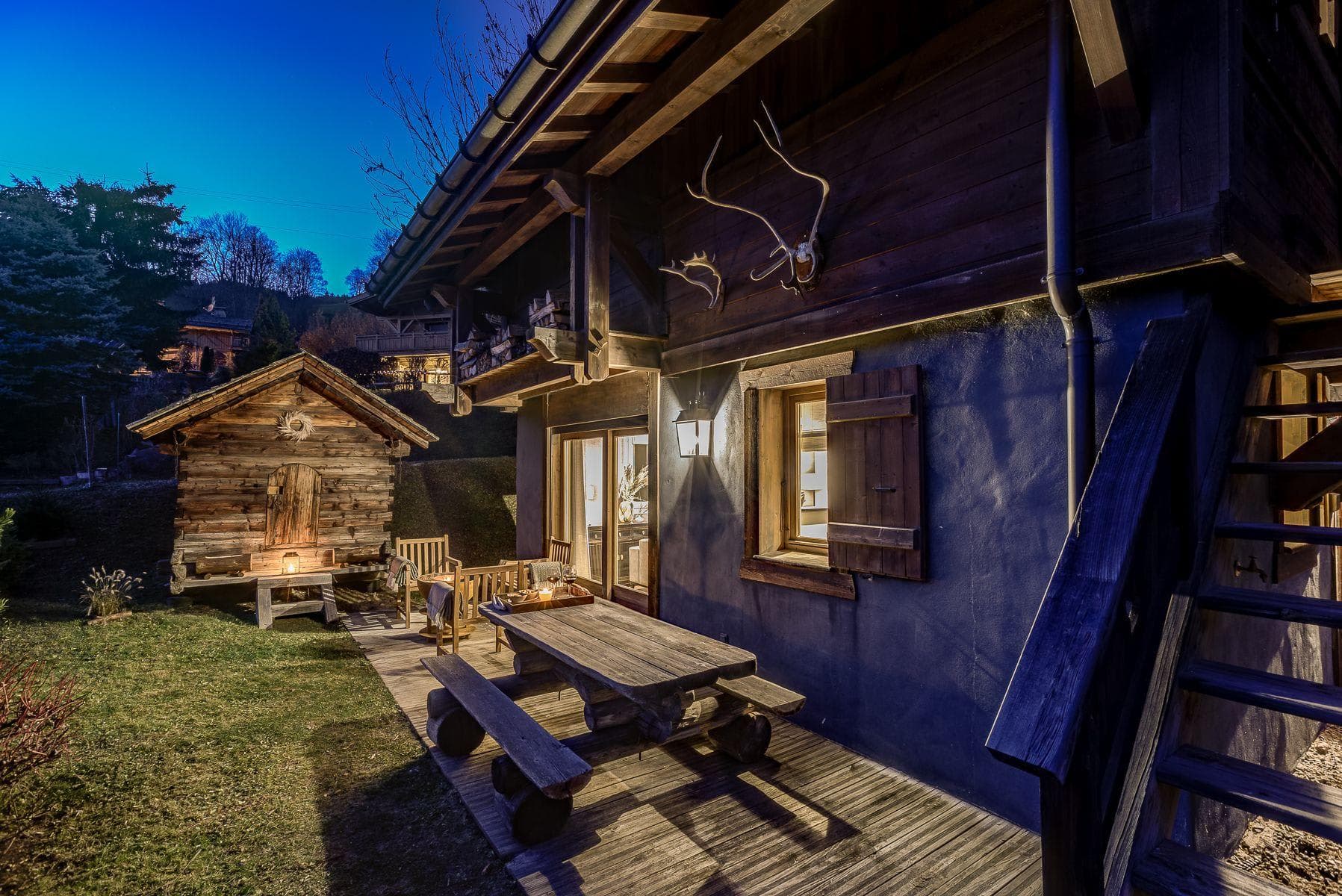 Ground floor patio with log picnic table and detached garden sauna