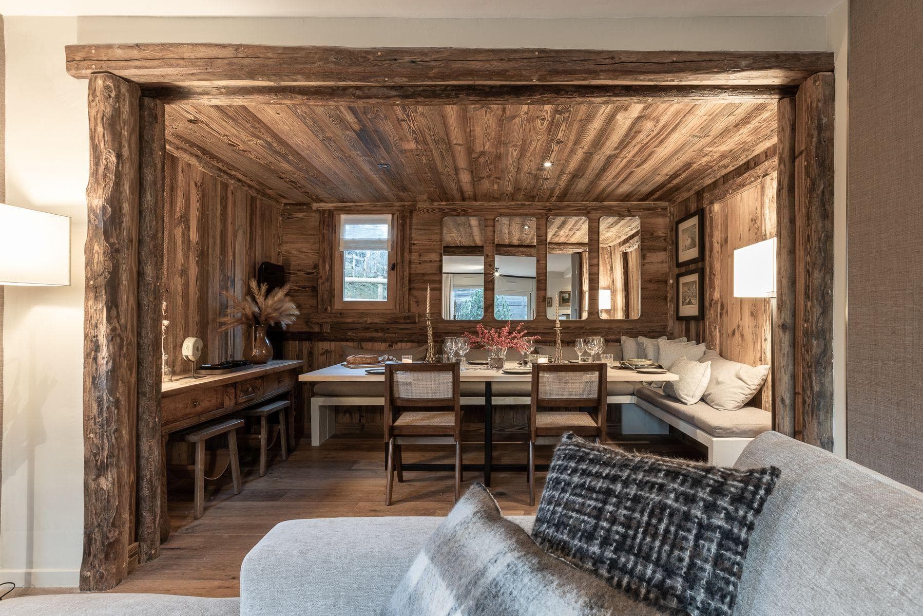 Dining nook with built-in banquette seating and reclaimed timber paneling