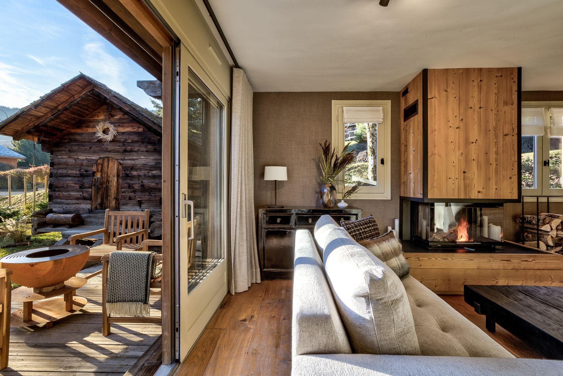 Living area with wood-burning fireplace and sliding doors to deck