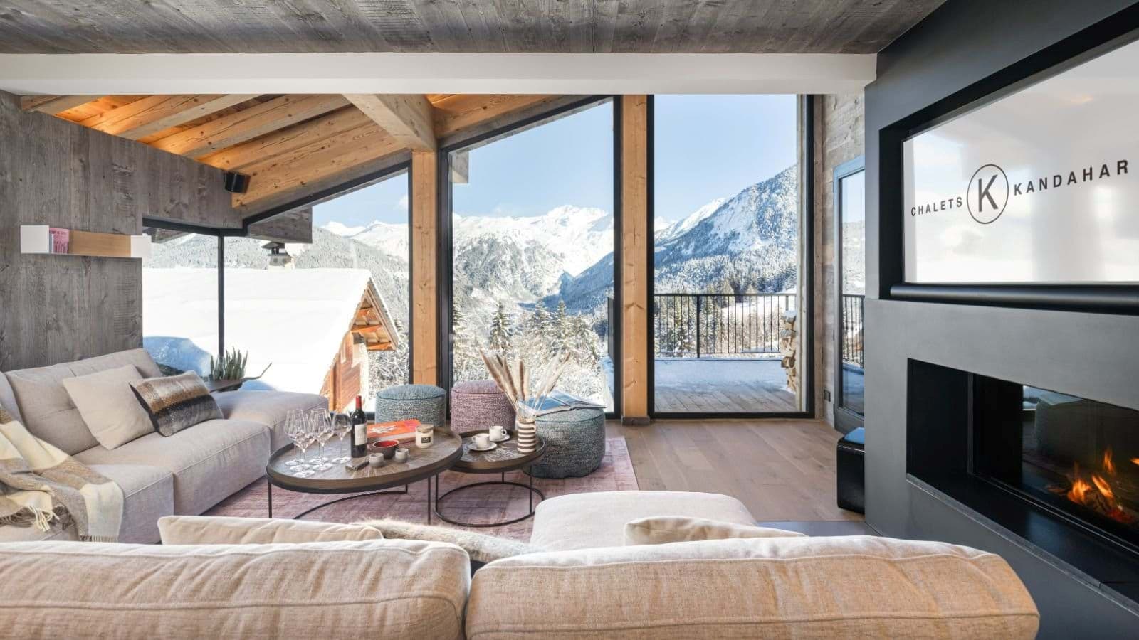 Living area with fireplace and floor-to-ceiling mountain views