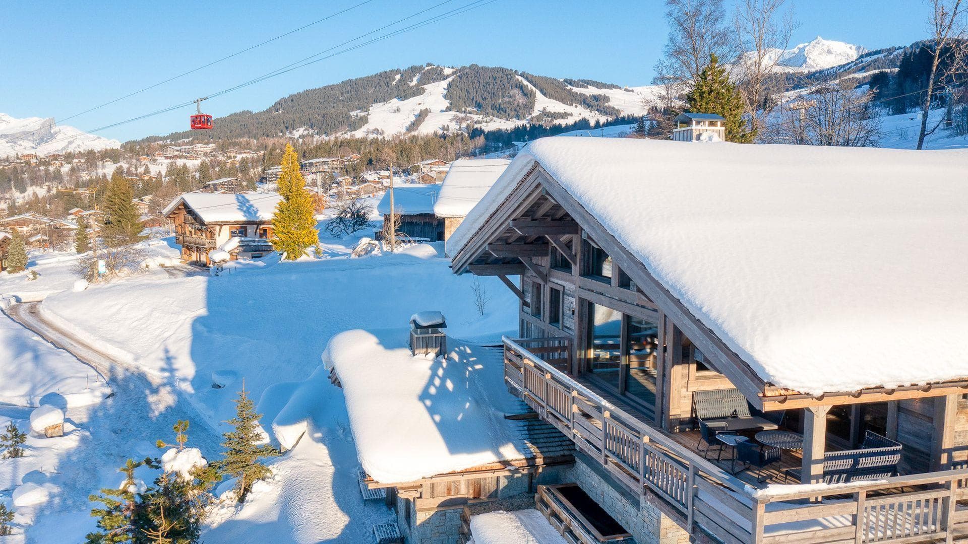 Chalet exterior with wrap-around balcony and mountain views near gondola