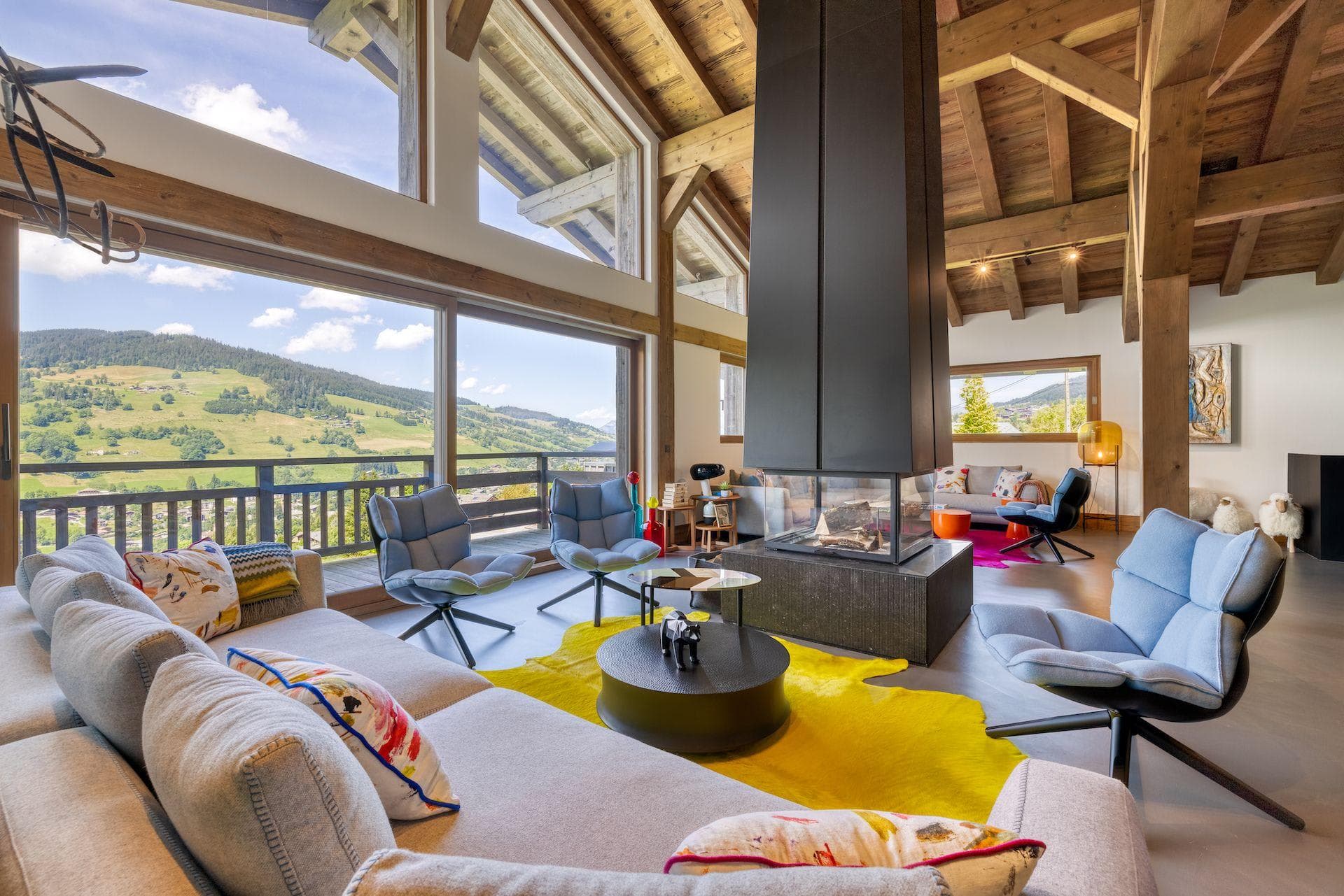 Living area with 360-degree central fireplace and valley views