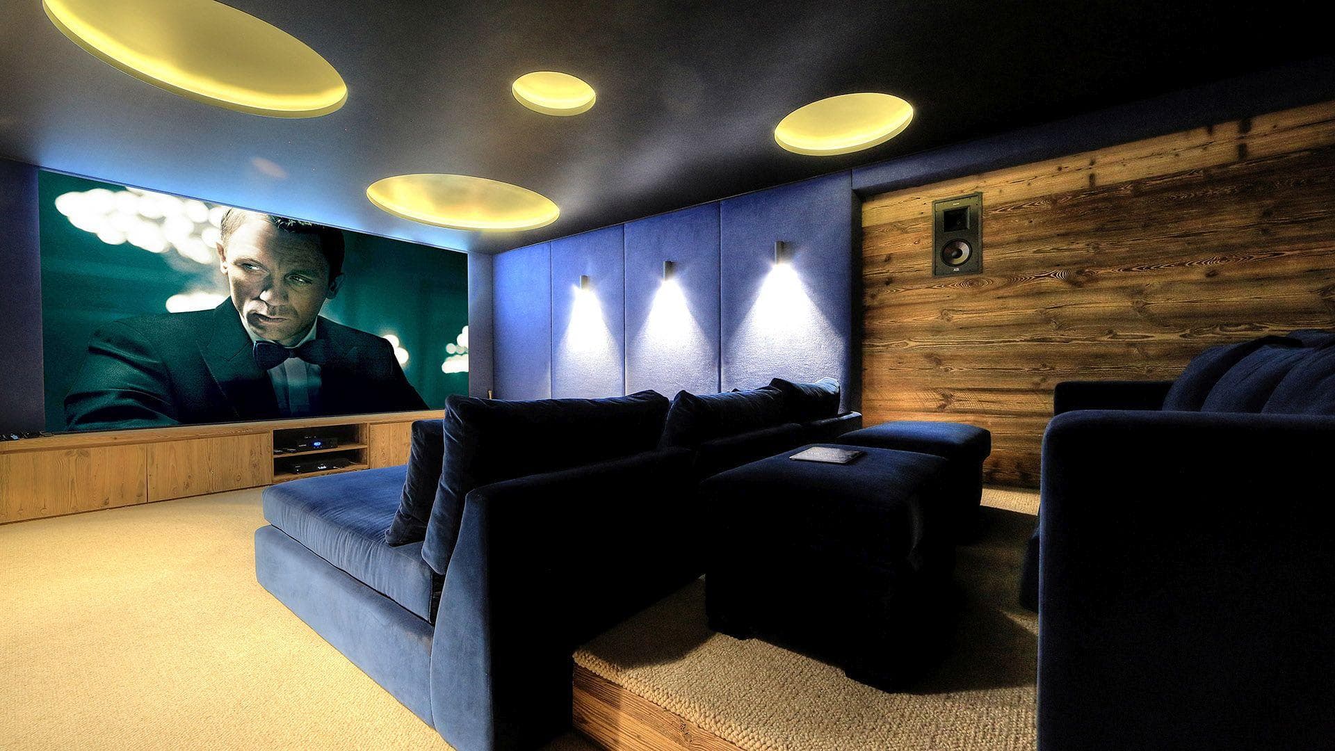 Media room with tiered velvet seating and acoustic wall panels