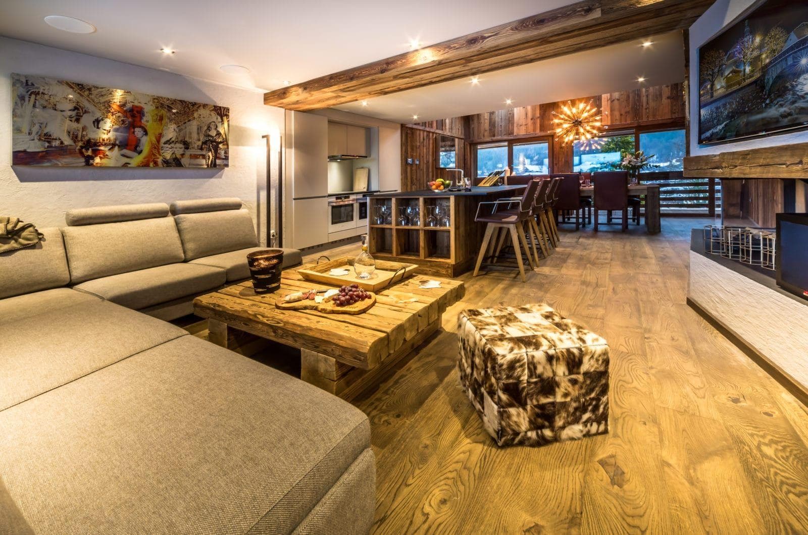 Open-plan living area with integrated kitchen, breakfast bar, and wood-burning fireplace
