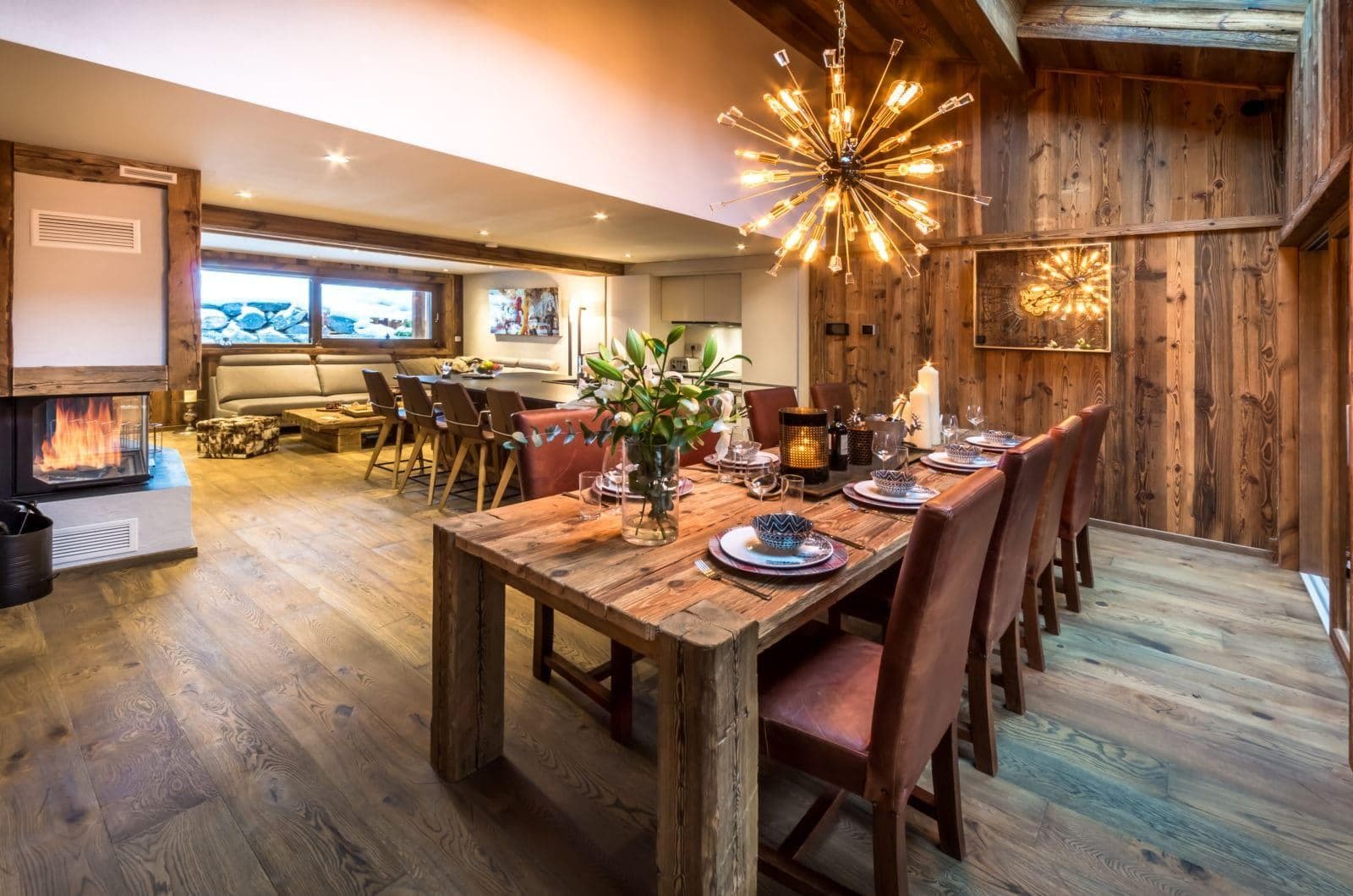 Open-plan dining area with seating for 8 near wood-burning fireplace