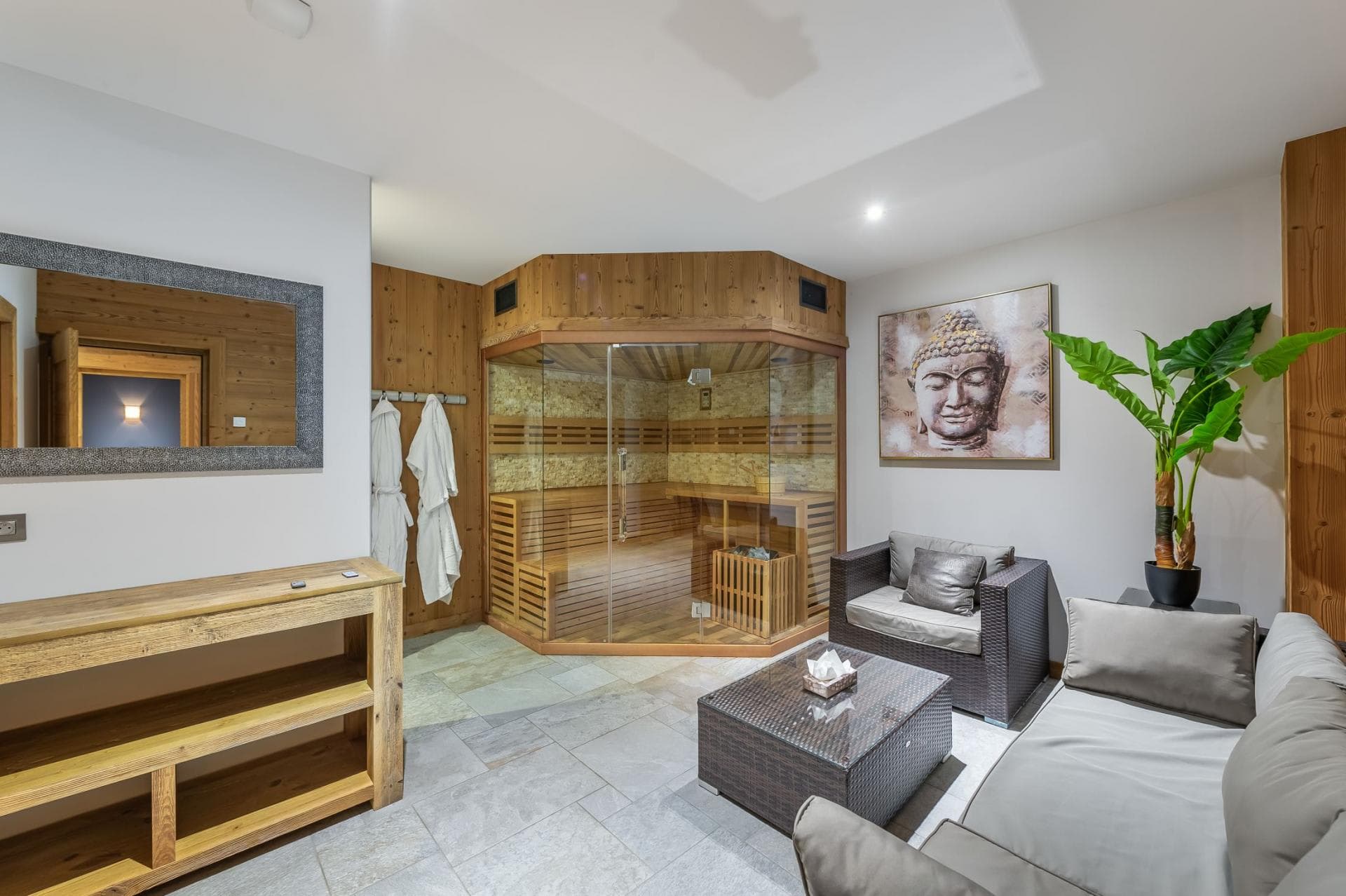 Private glass-front sauna and relaxation lounge with stone tile flooring