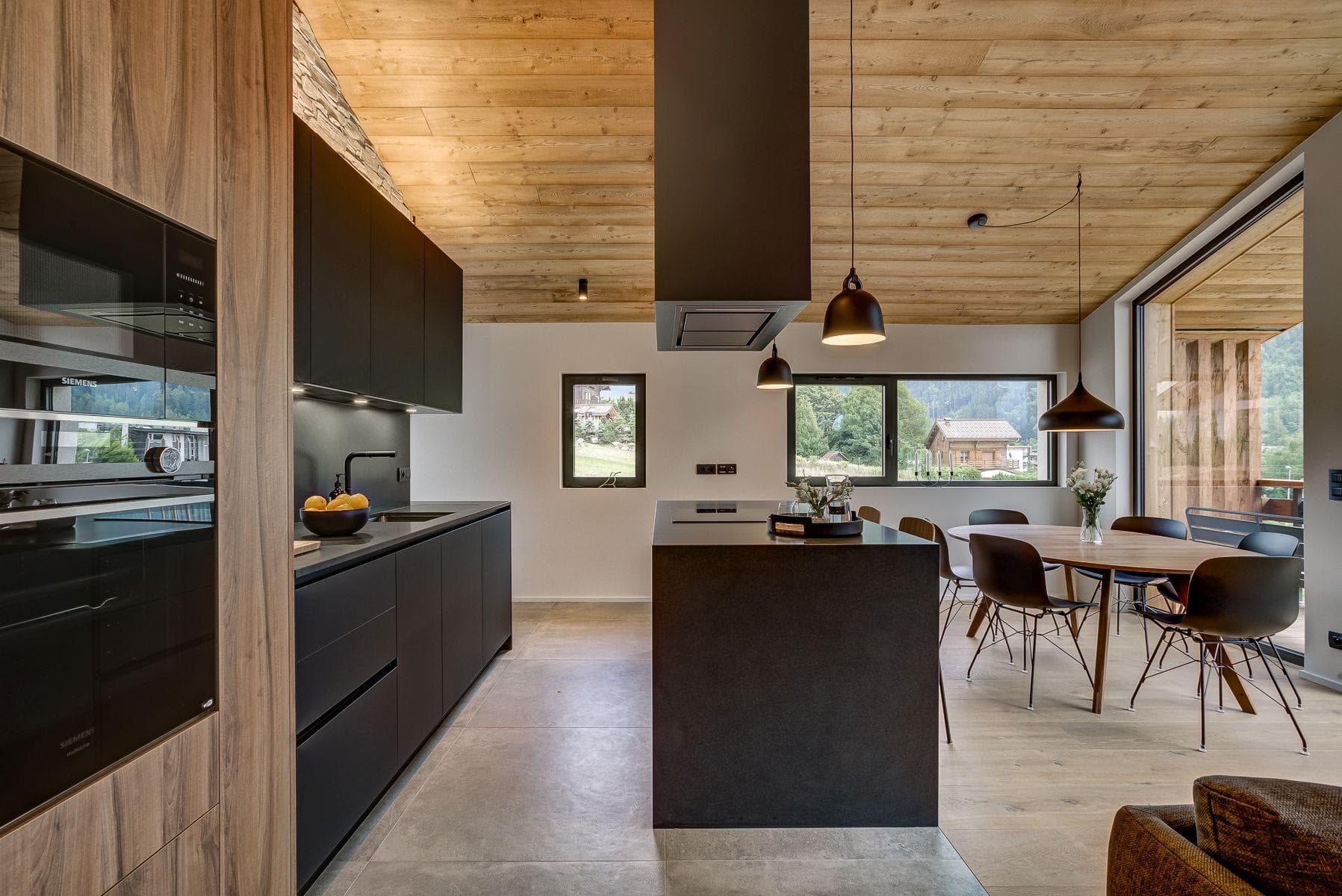 Kitchen with Siemens wall oven and dining table seating 6