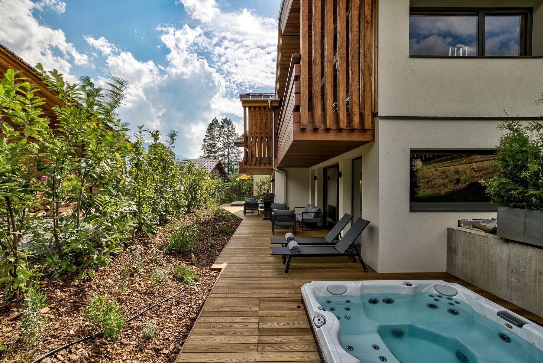 Private deck with hot tub, sun loungers, and gas grill