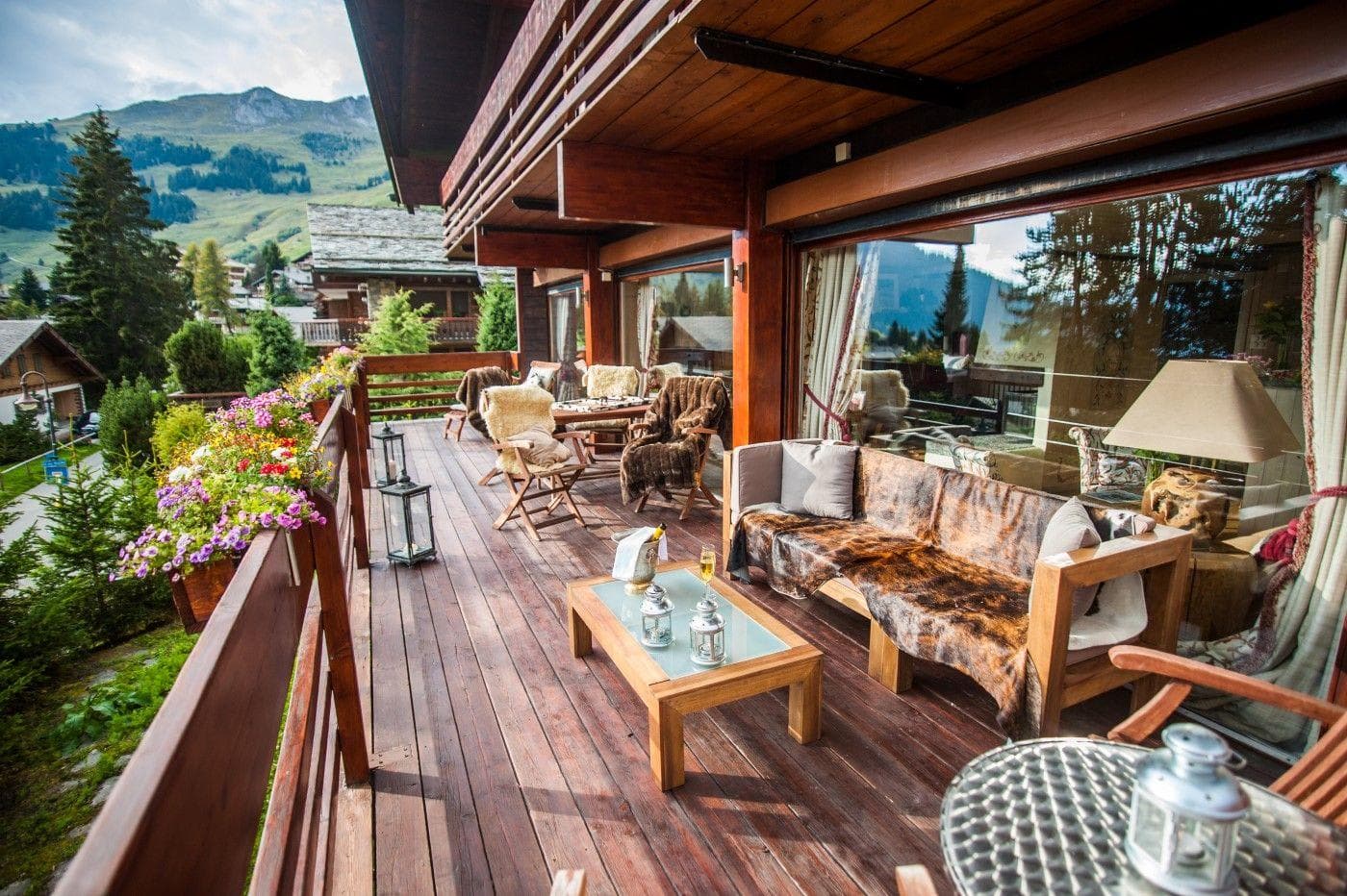 Covered wooden deck with lounge seating and mountain valley views
