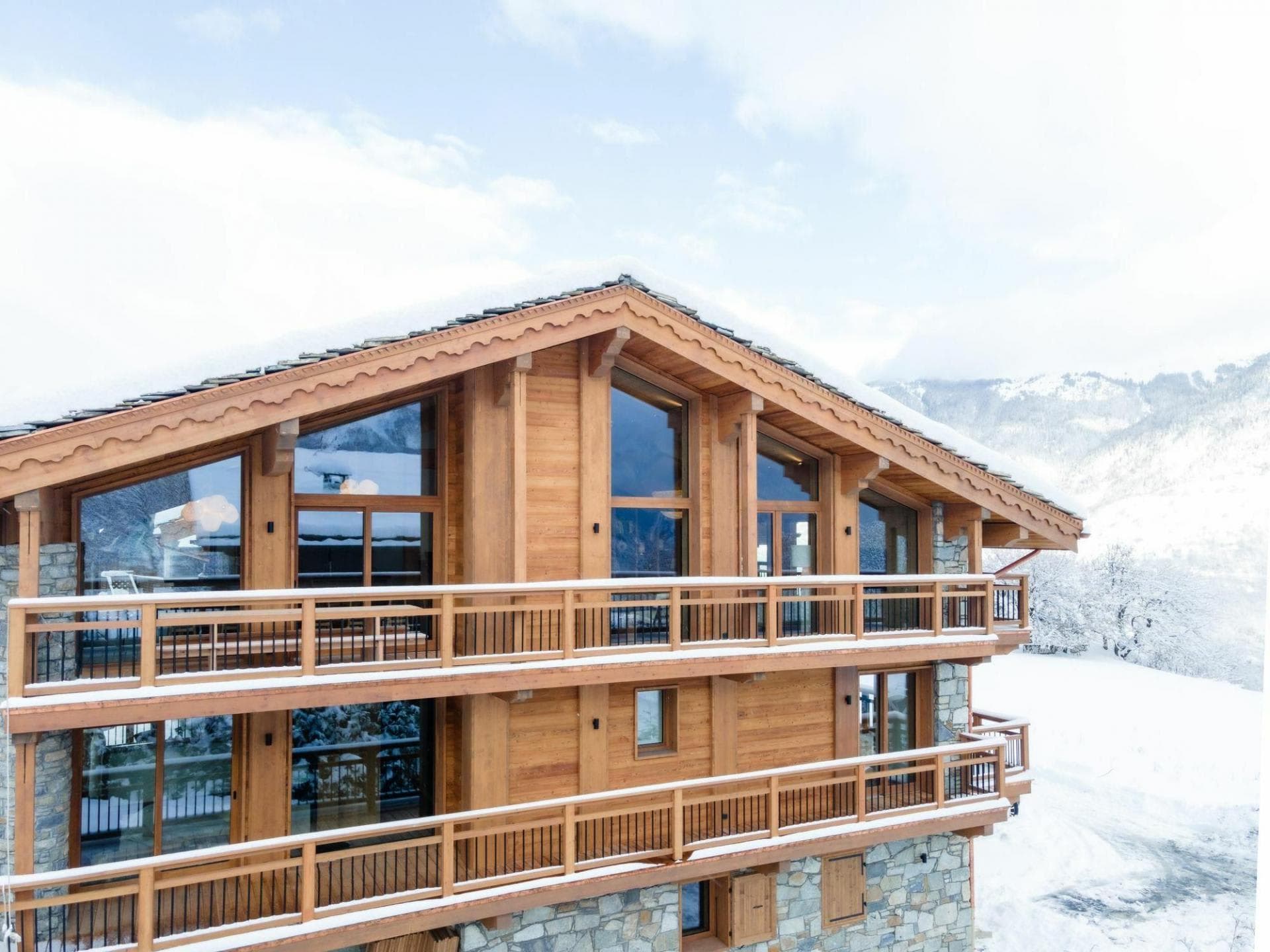 Chalet exterior with two levels of balconies and floor-to-ceiling windows