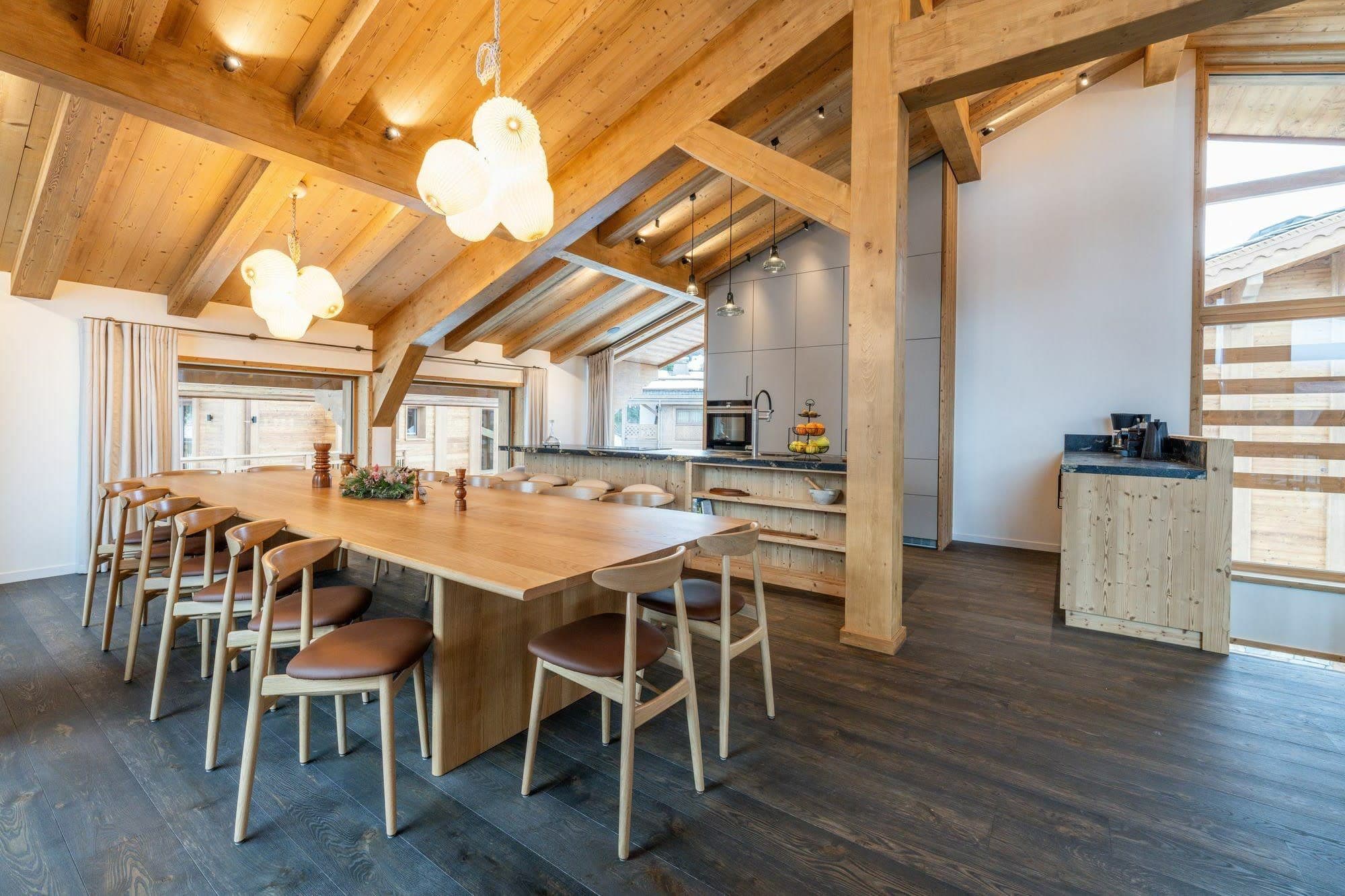 Dining area seating 10 with vaulted ceilings and integrated kitchen bar