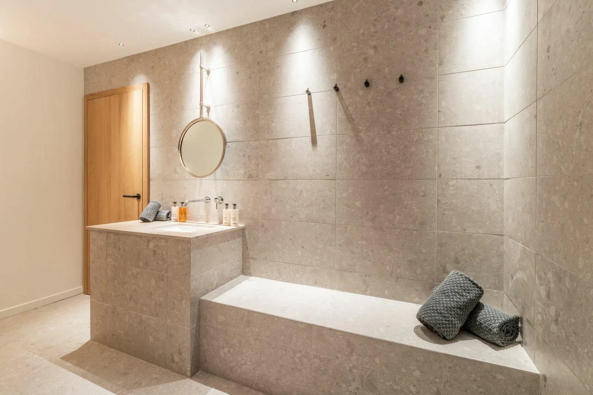 Stone vanity and integrated bench in the wellness area