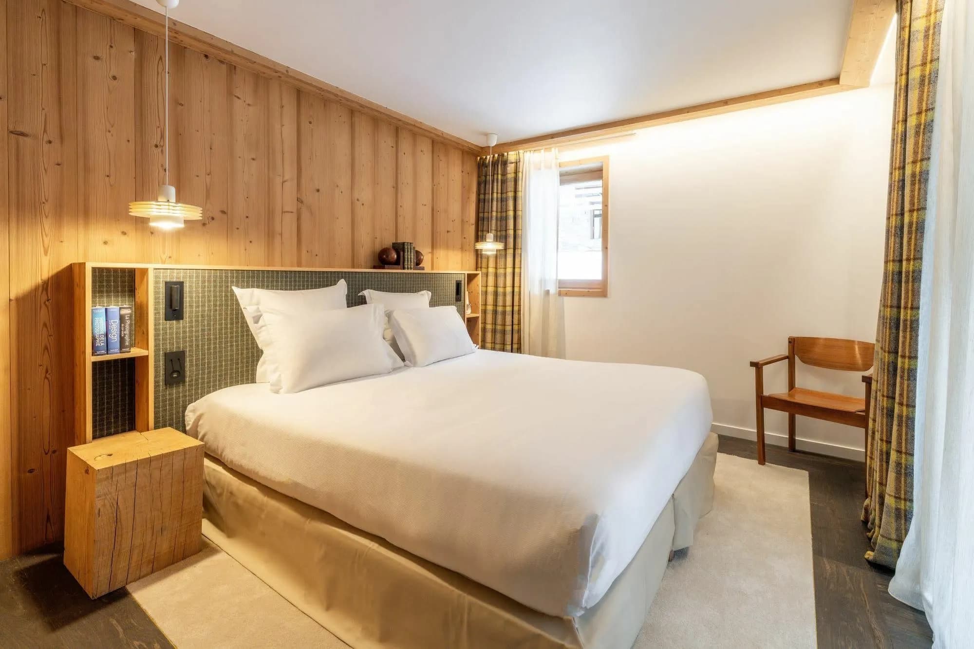 Guest bedroom with built-in shelving and integrated reading lights