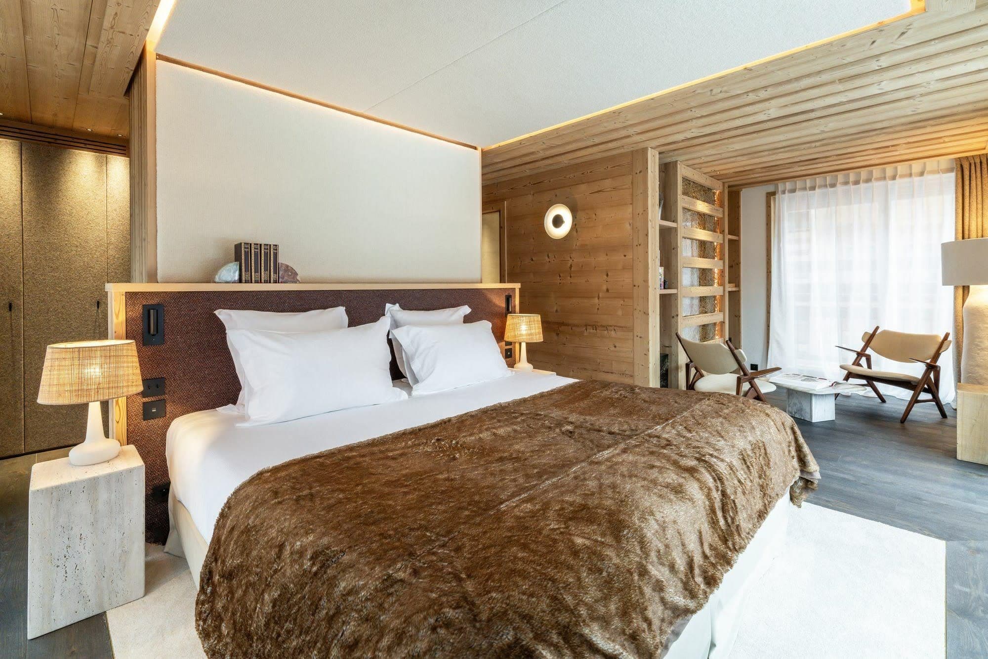 Master bedroom with a king-size bed and adjoining seating area