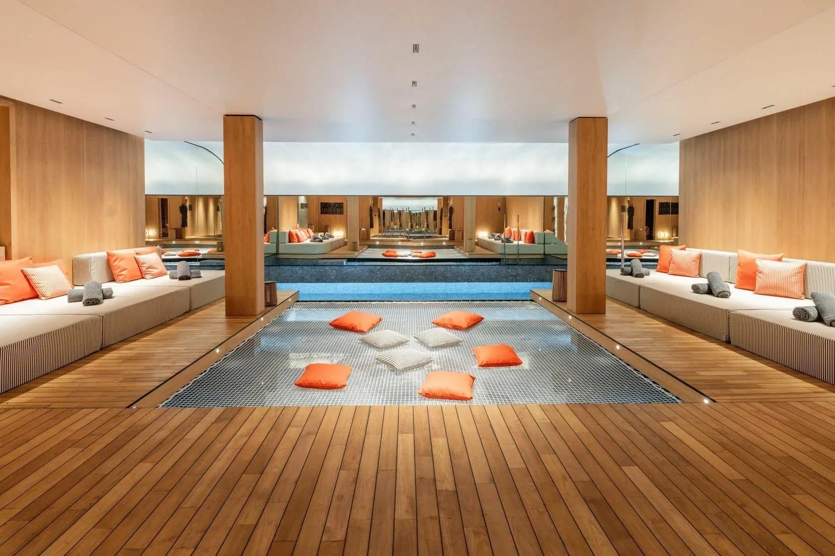 Spa lounge with built-in daybeds beside the indoor swimming pool