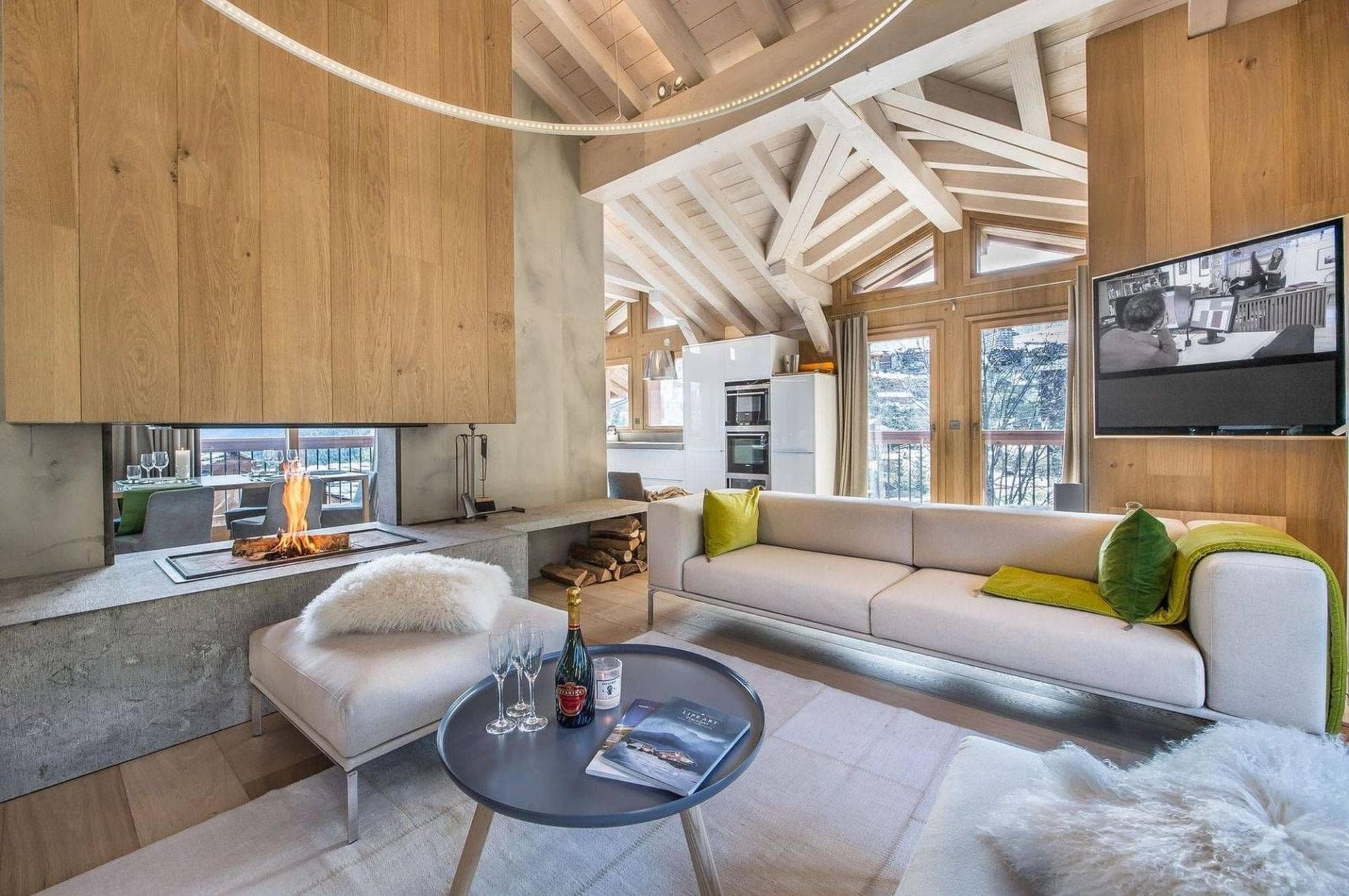 Living area featuring double-sided fireplace and vaulted wood ceilings