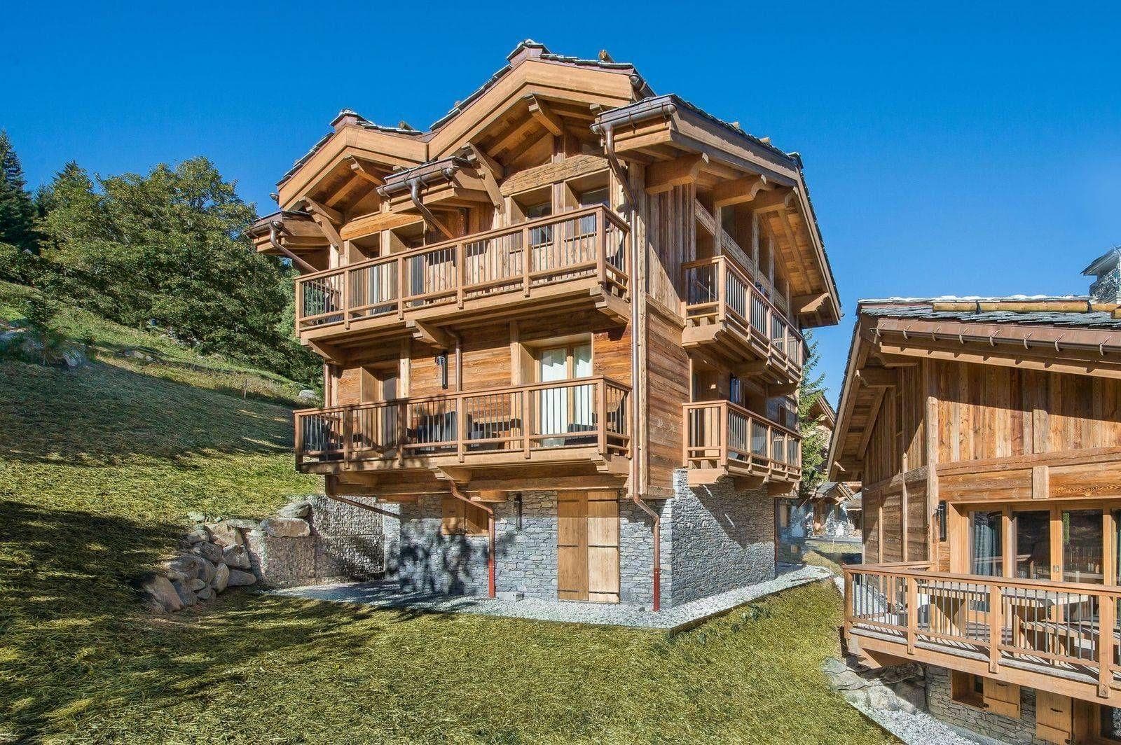 Ski-in/ski-out chalet with multi-level private balconies and stone foundation