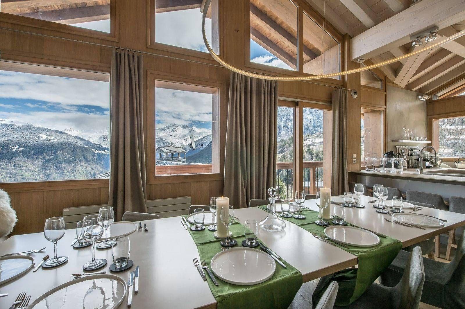 Dining area for 10 with mountain views and adjacent breakfast bar