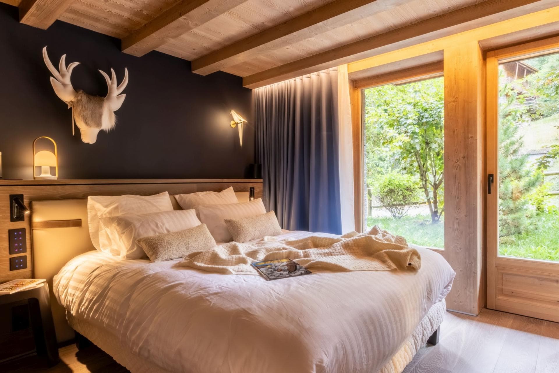 King bedroom with floor-to-ceiling windows and garden access