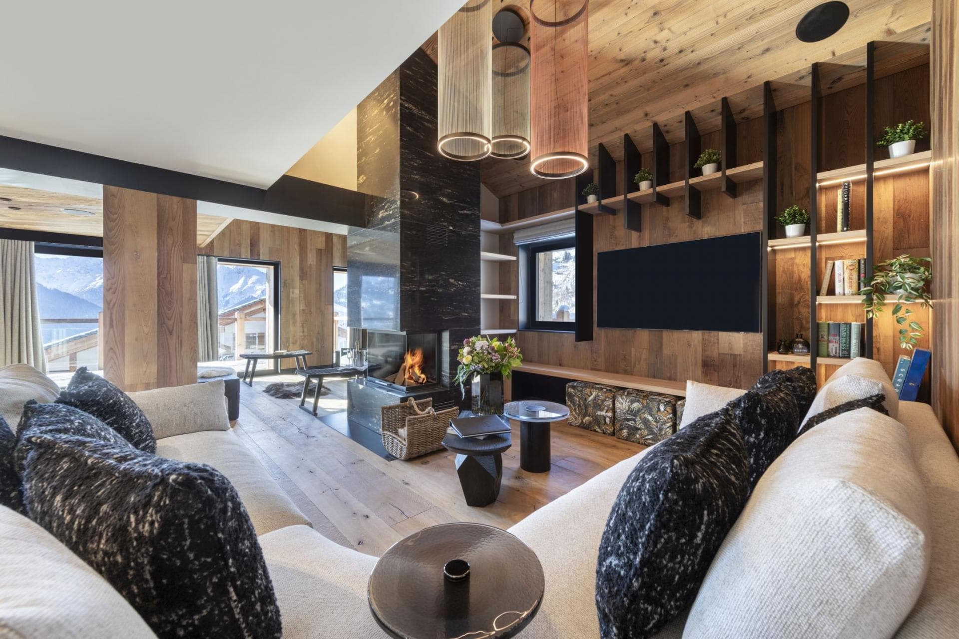 Living area with wood-burning fireplace and mountain-view balcony access