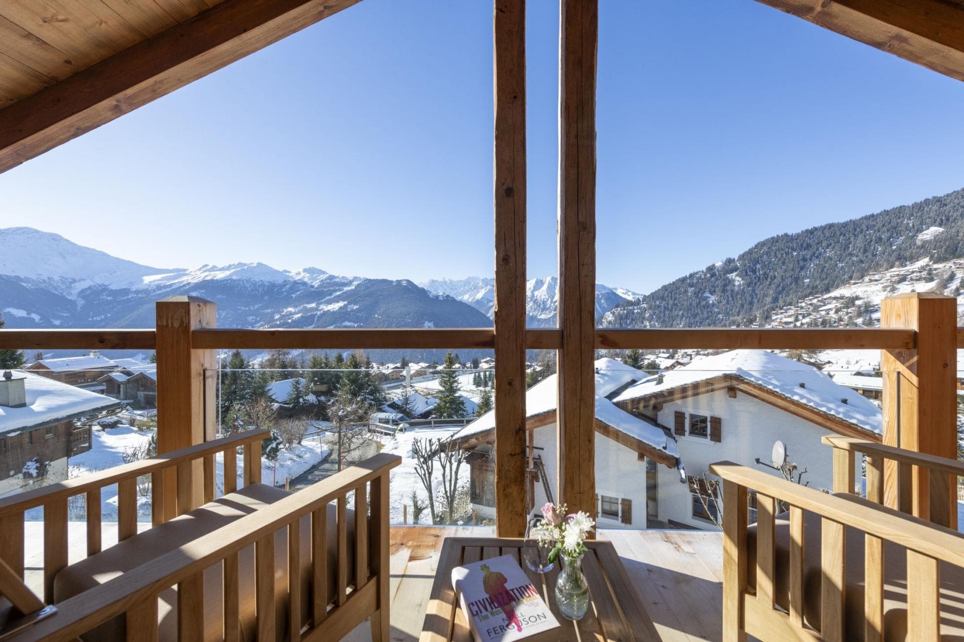 Covered balcony with mountain views and glass safety railings