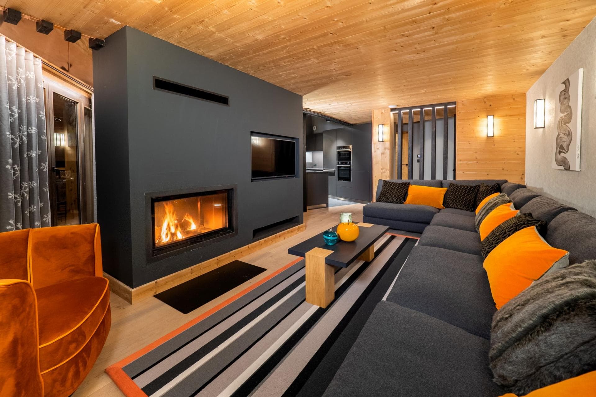 Living area with wood-burning fireplace and sectional seating for 8