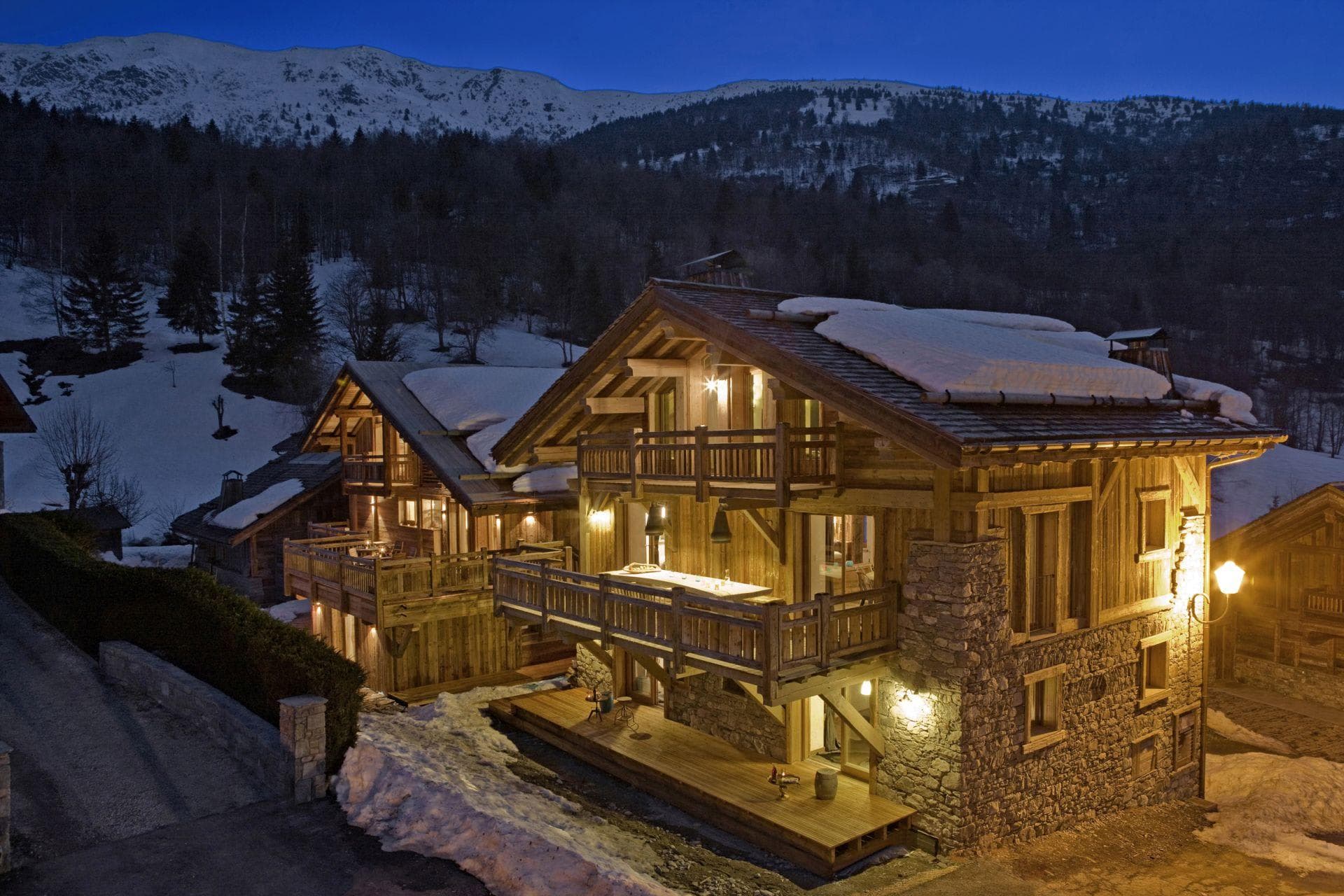 Chalet exterior with multiple balconies and private terrace; mountain views