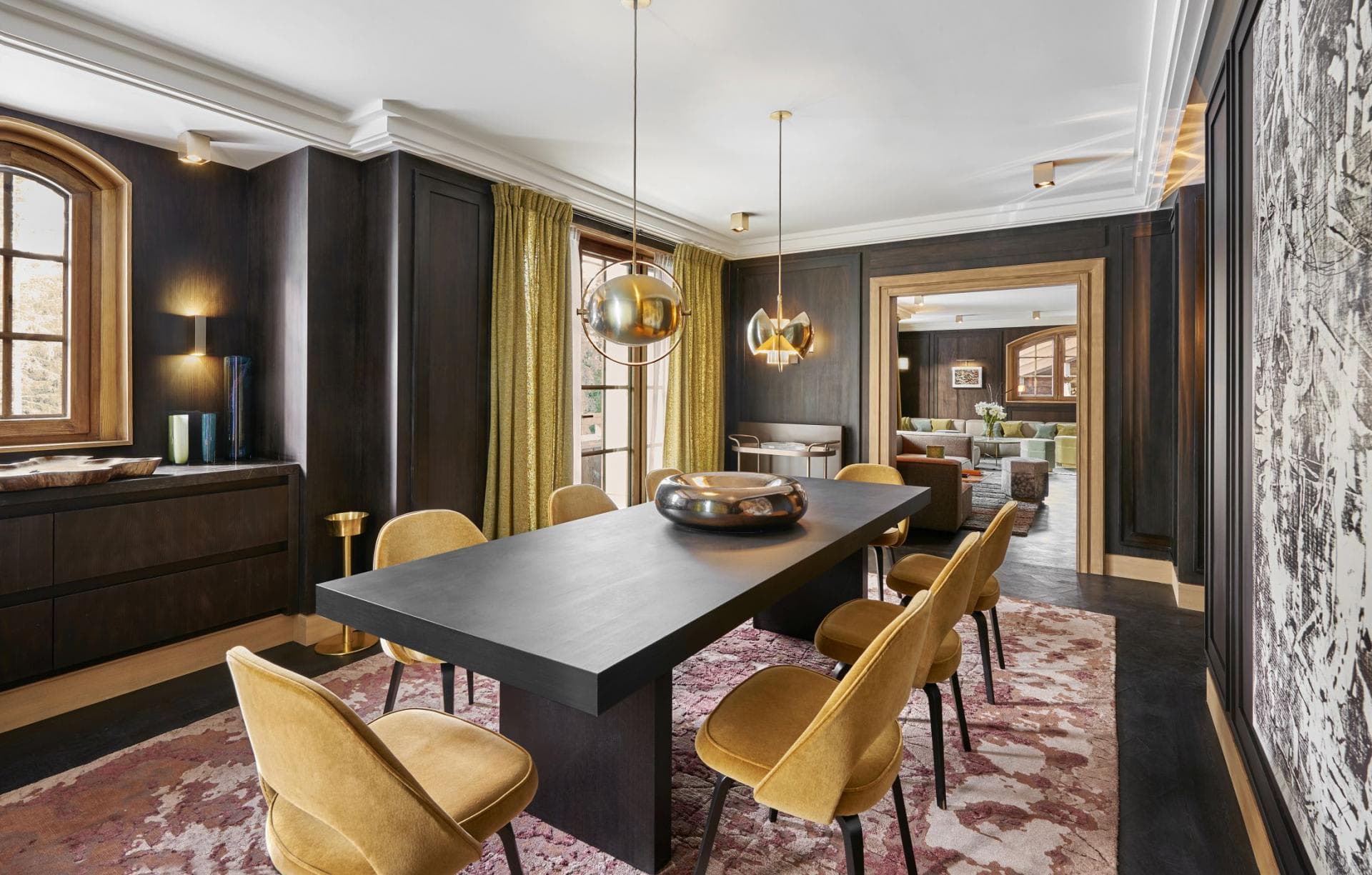 Dining room with seating for 8 and dark wood paneled walls