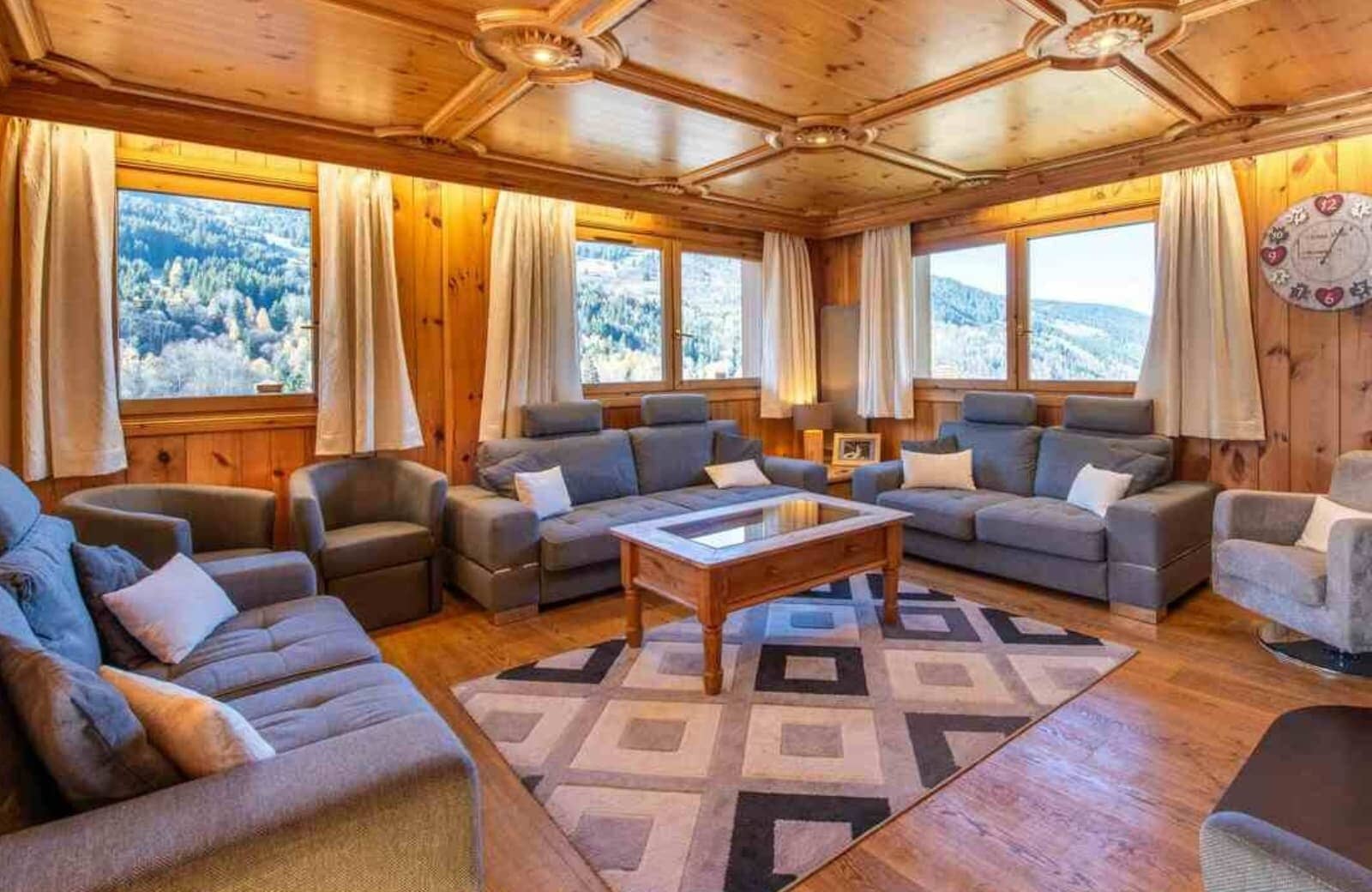 Living area with wood-paneled coffered ceiling and mountain views