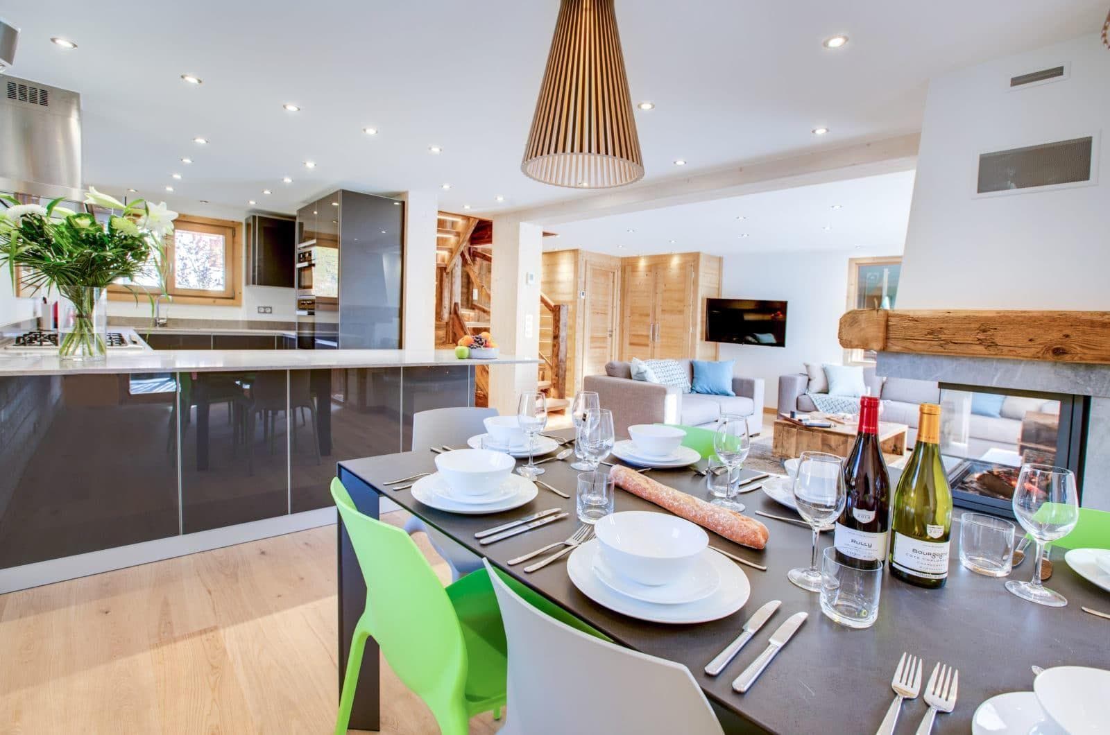 Dining area seats 6 with double-sided fireplace and kitchen with gas range