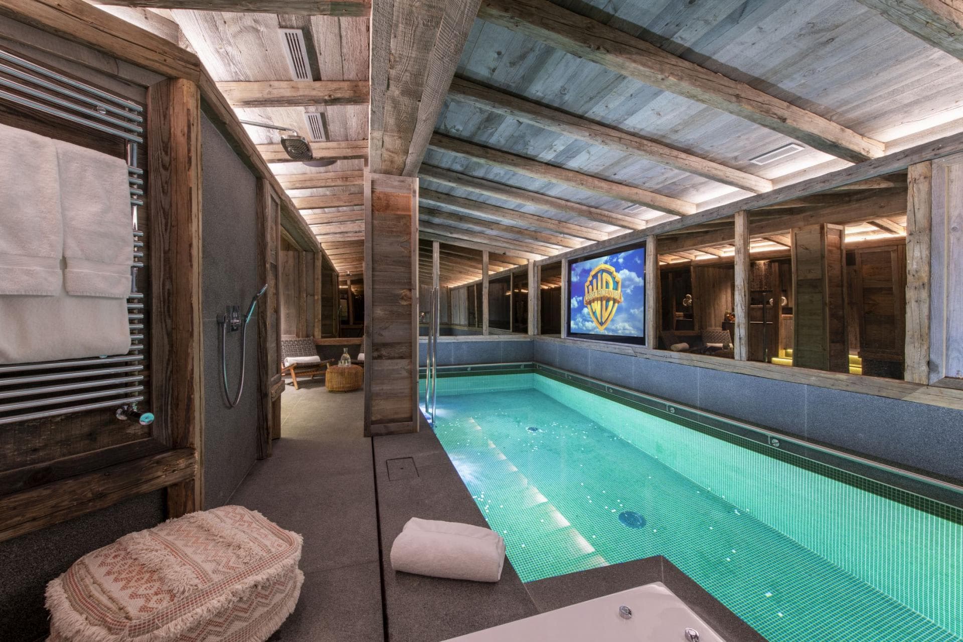 Indoor pool with cinema screen and heated towel rack