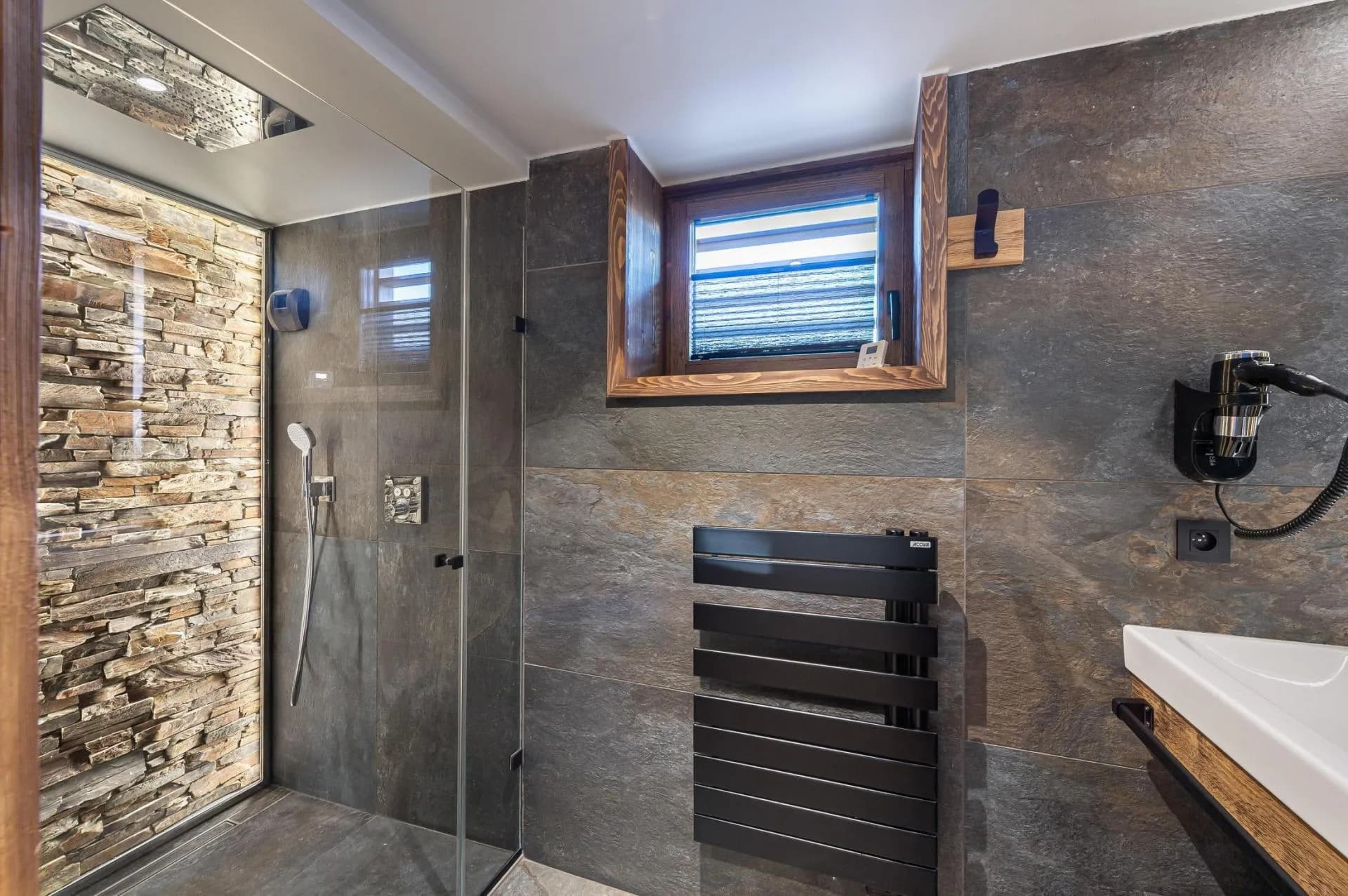 En-suite shower room with walk-in shower and heated towel rail