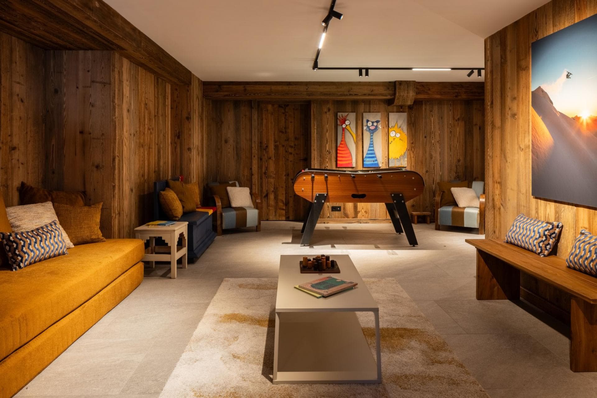 Game room with foosball table and wood-paneled lounge area