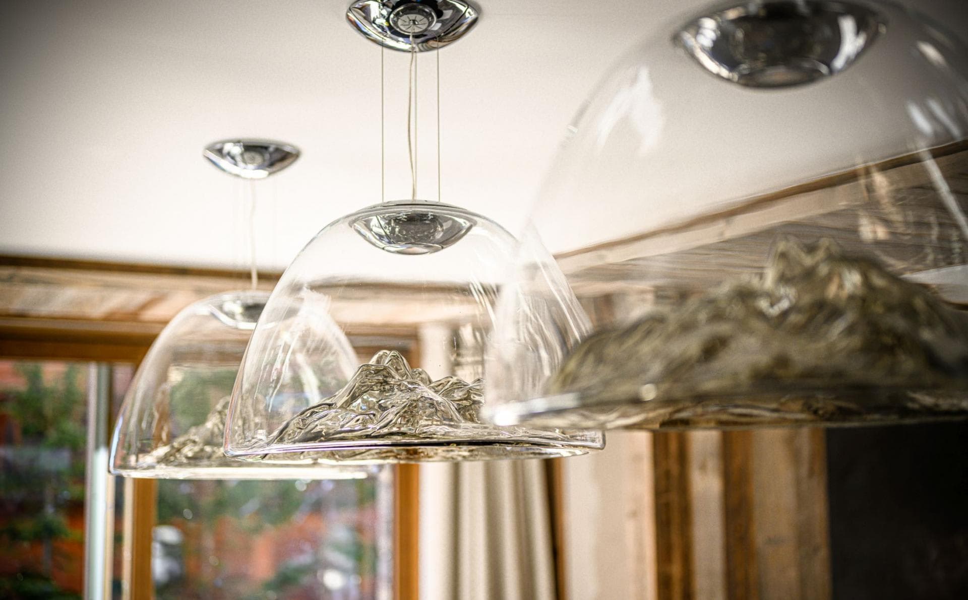 Custom glass pendant lights featuring hand-blown mountain range details