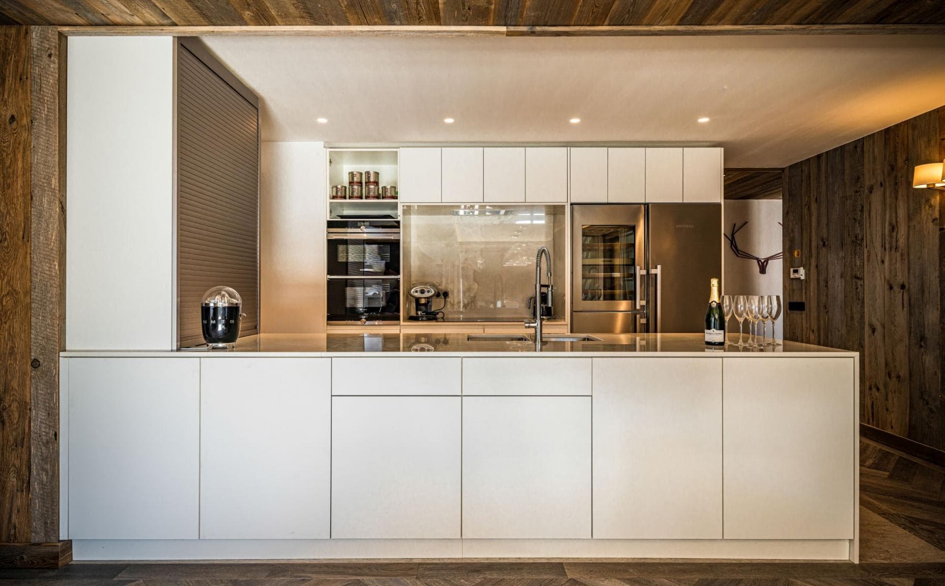 Kitchen with built-in wine fridge, dual ovens, and Smeg espresso machine